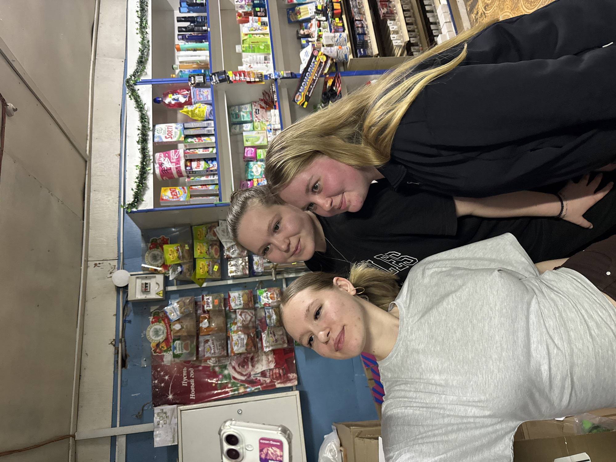 Two women document casual store visit in rural Russia