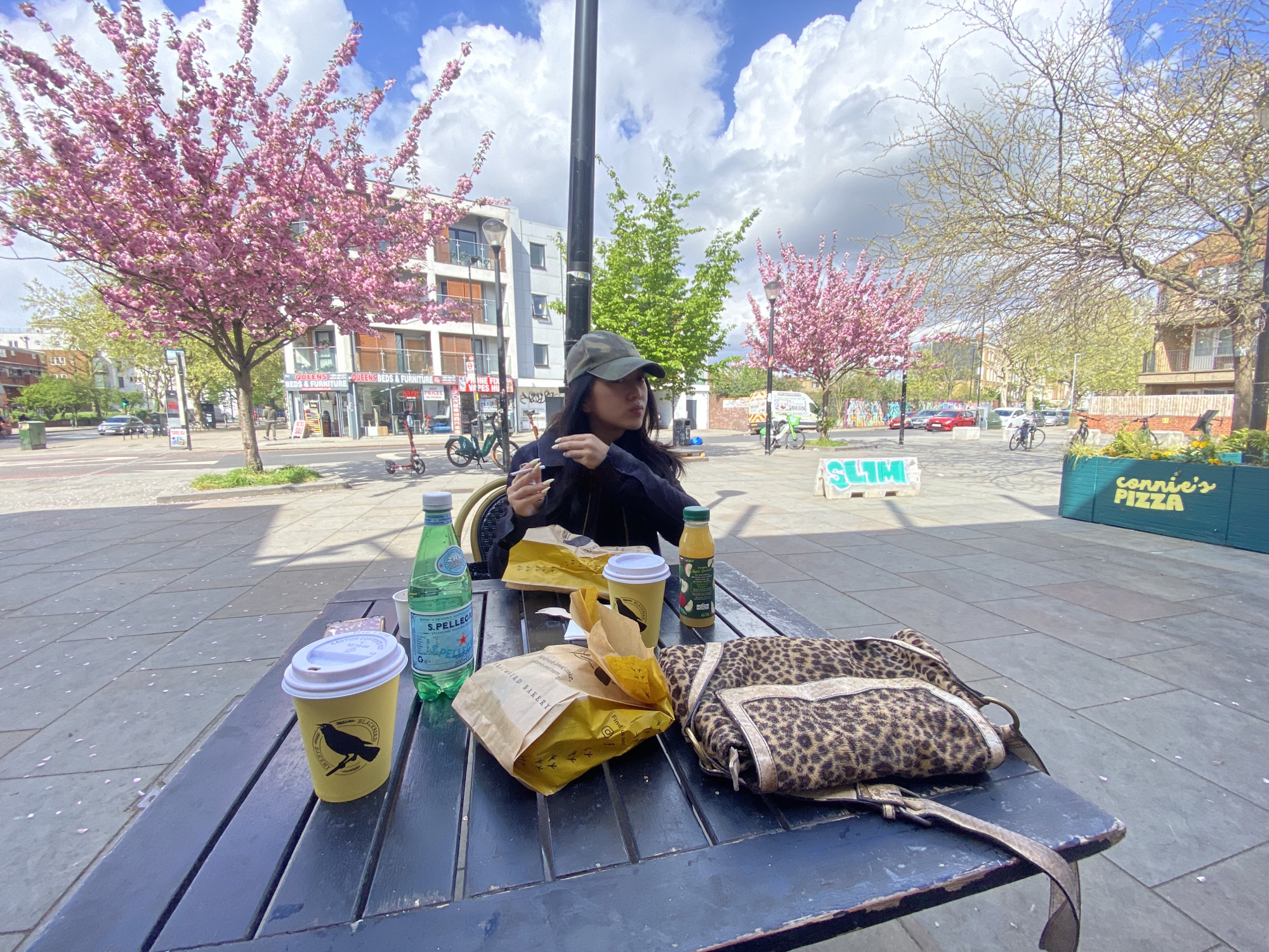 Woman enjoys Blackbird Bakery meal at London picnic table
