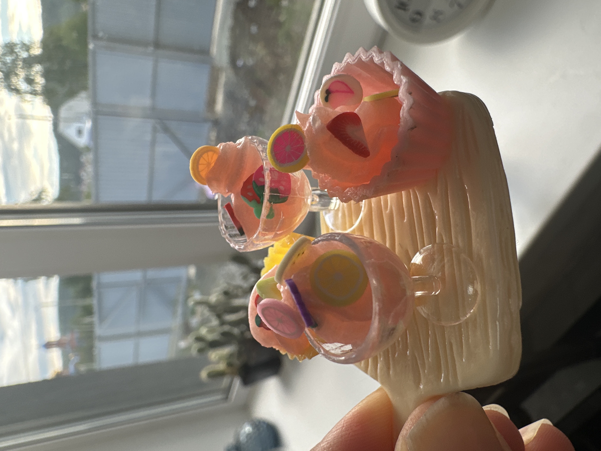 Cat examines miniature dessert decorations in indoor display session