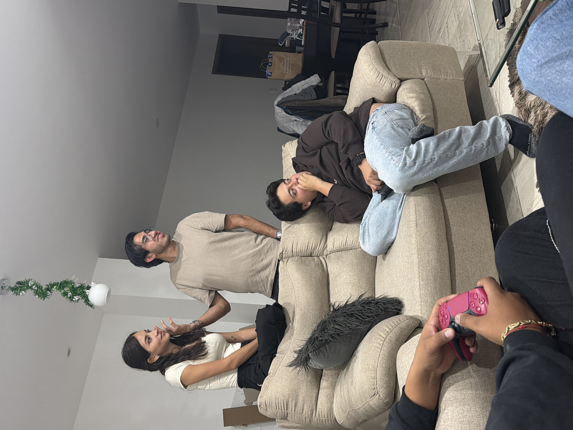 Four people gather on couch in Mexican living room