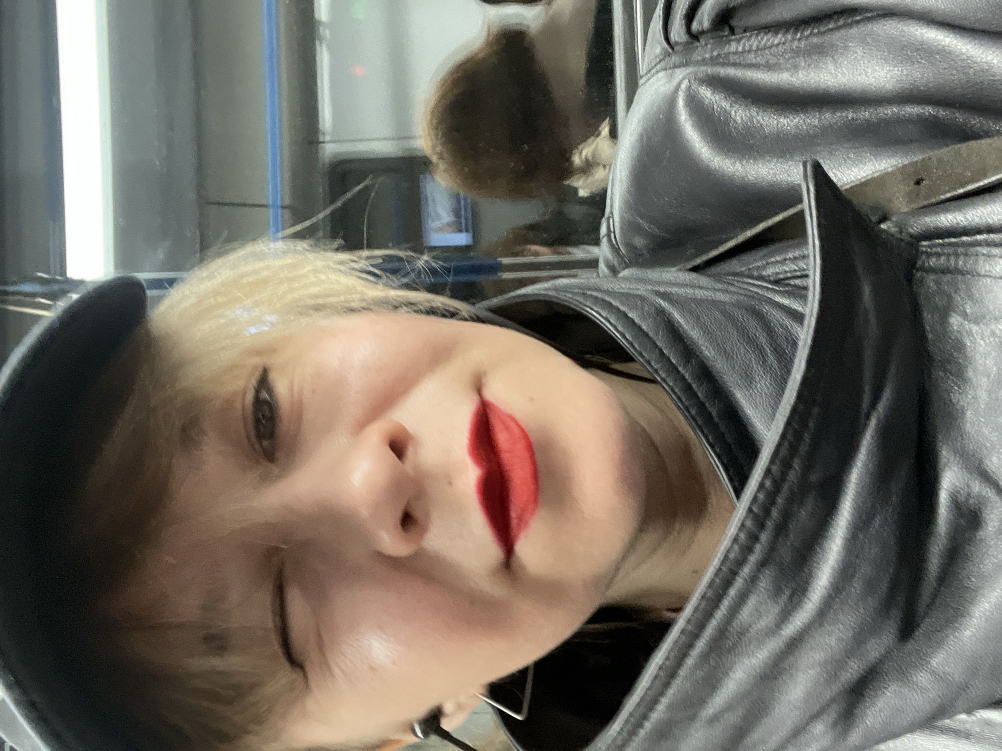 Woman in leather jacket winks in Moscow street scene