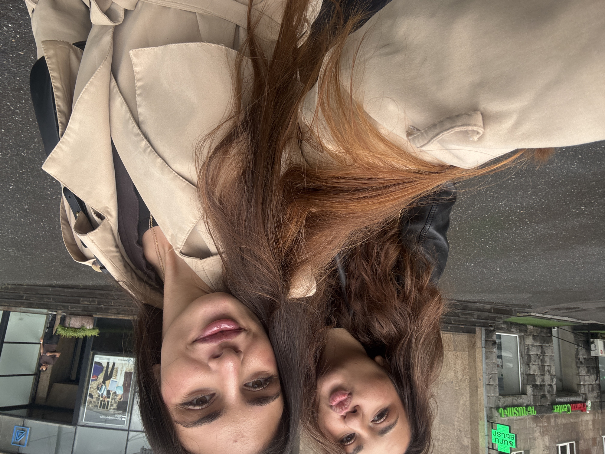 Two women photographed on rainy Yerevan street
