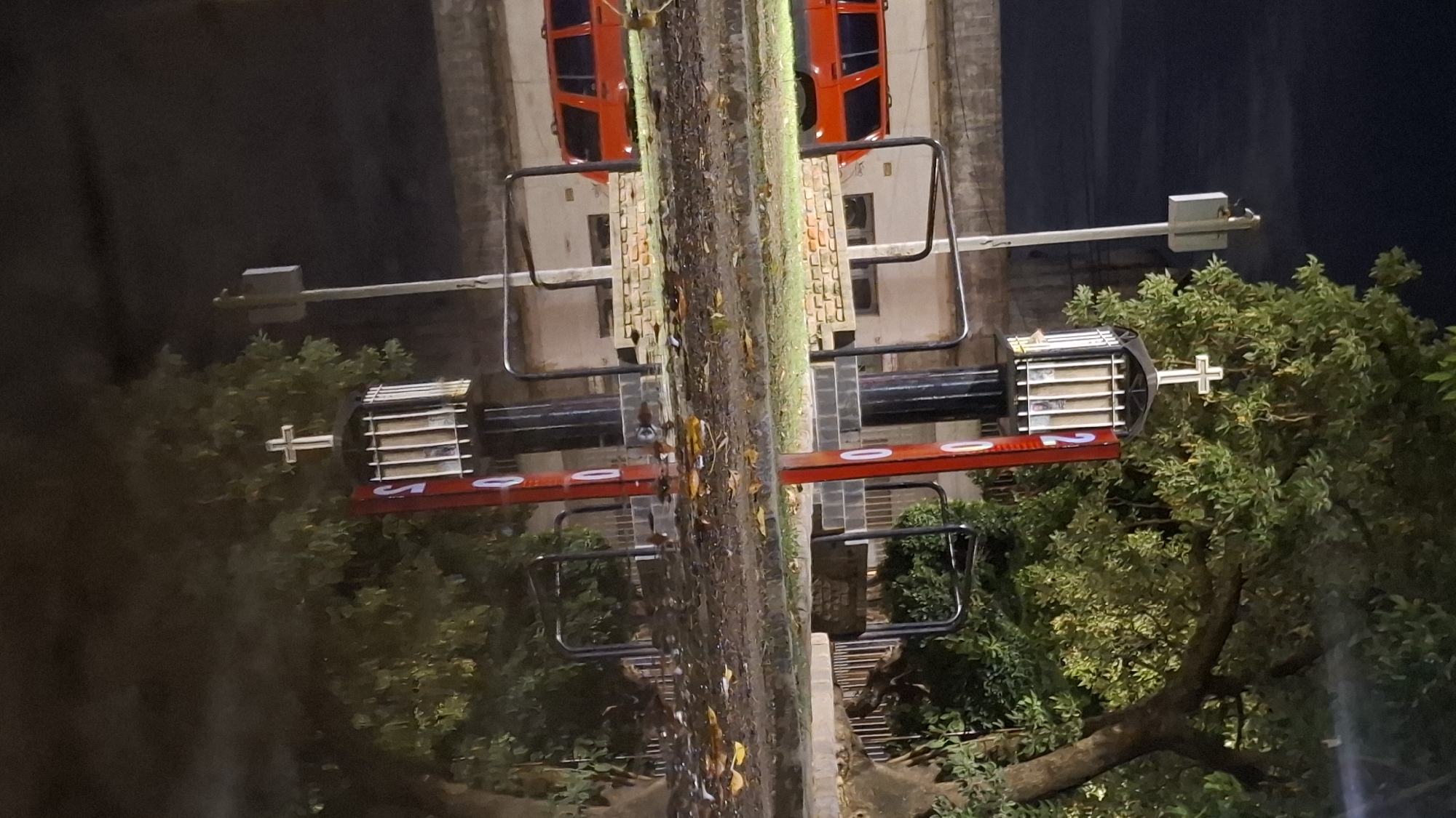 Orange-cabin ride structure spotted at night in Villa Domínico