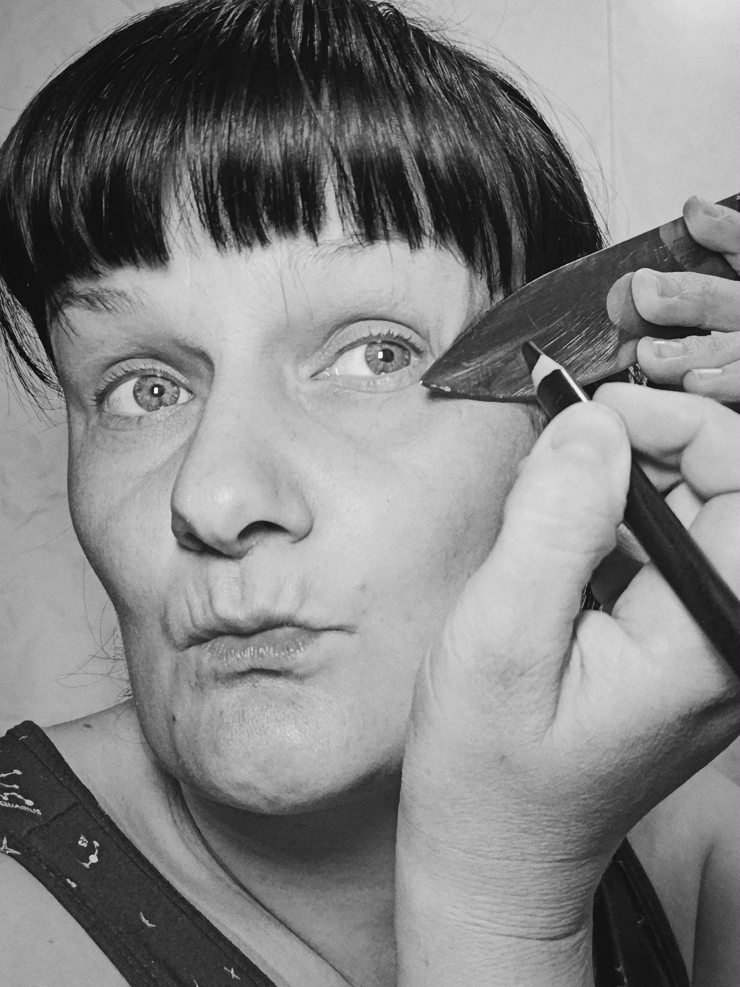 Woman documented in morning routine with baby, makeup, kitchen knife