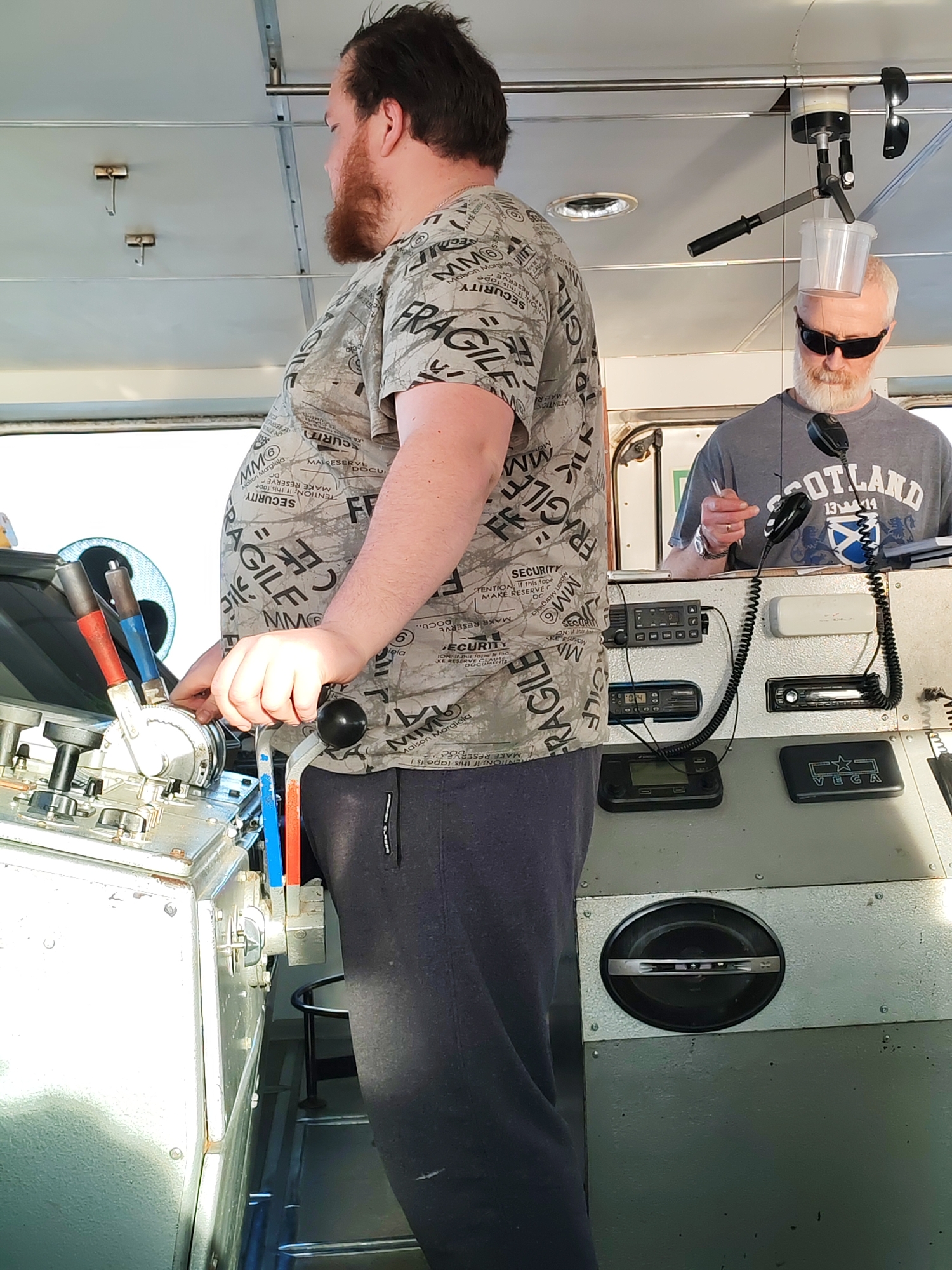 Two men photographed on vessel bridge in Pavlokovo