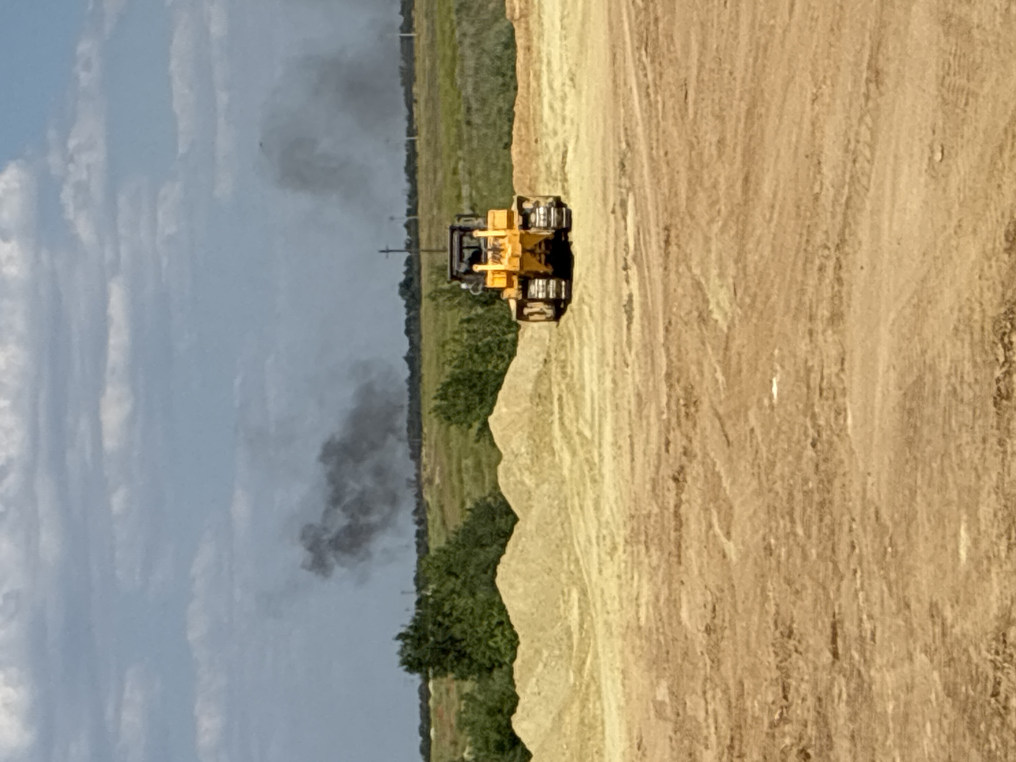 Bulldozer at work on a dusty construction site in Zhirnov