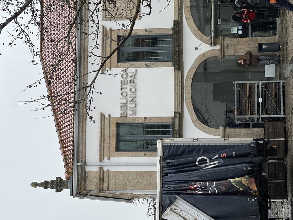 Tourist documents rainy afternoon walk through historic Bragança, Portugal