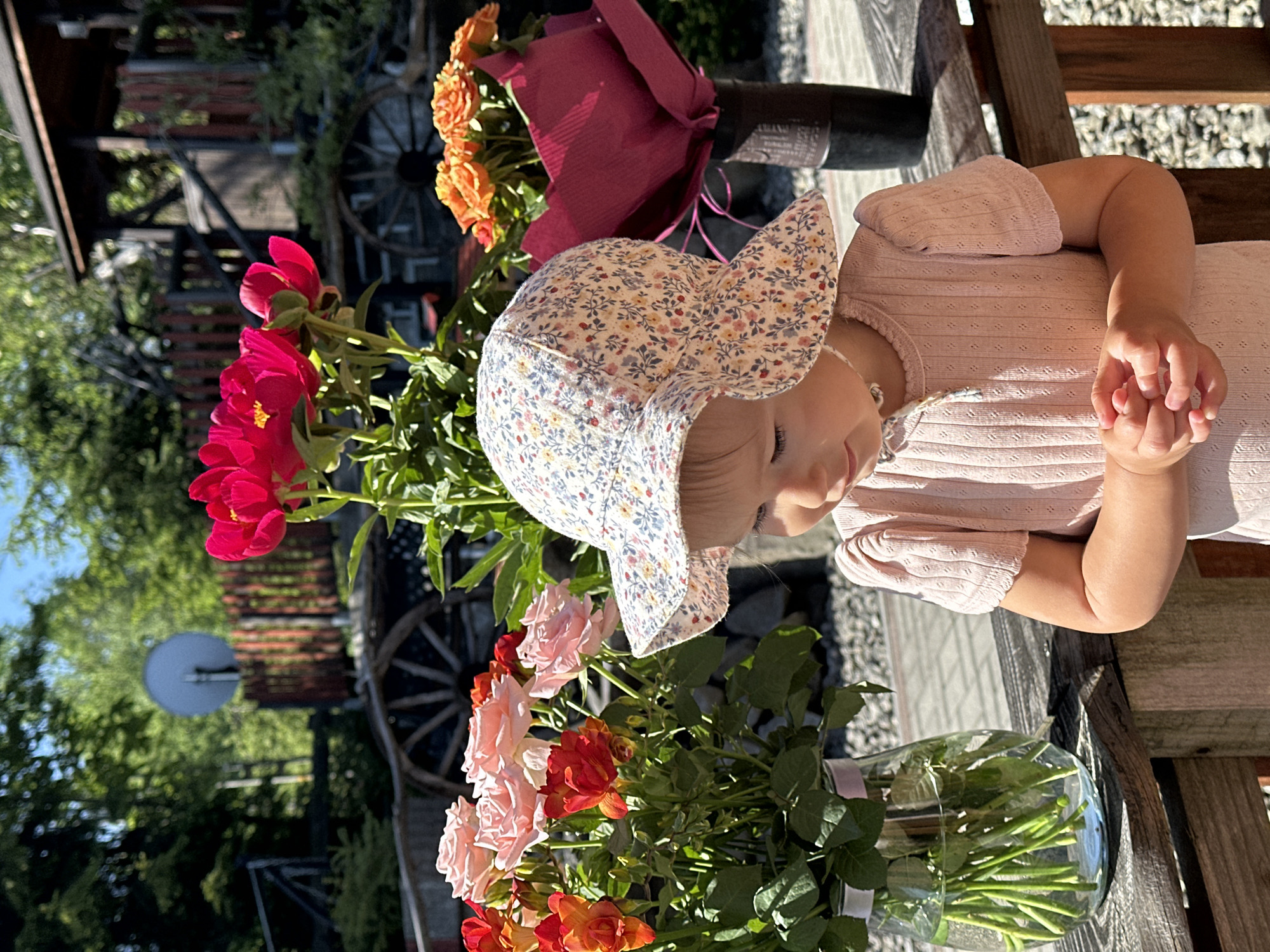 Baby photographed with peony bouquets in Wisła, Poland