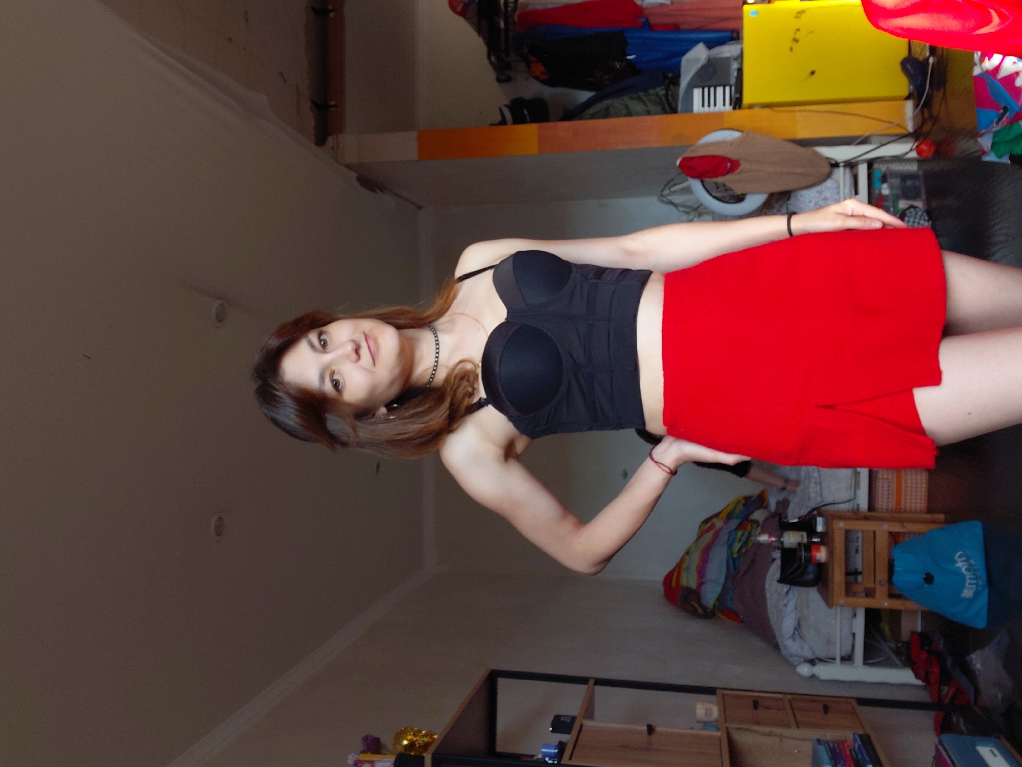 Indoor photo session in Magnitogorsk, styling a red and black outfit.