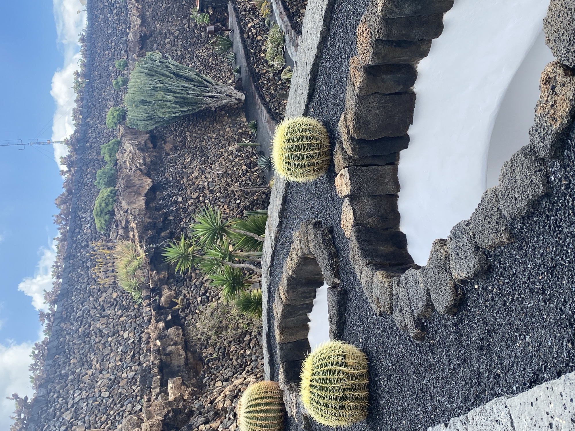 Tourists capture windmill, rock art in Teguise, Spain