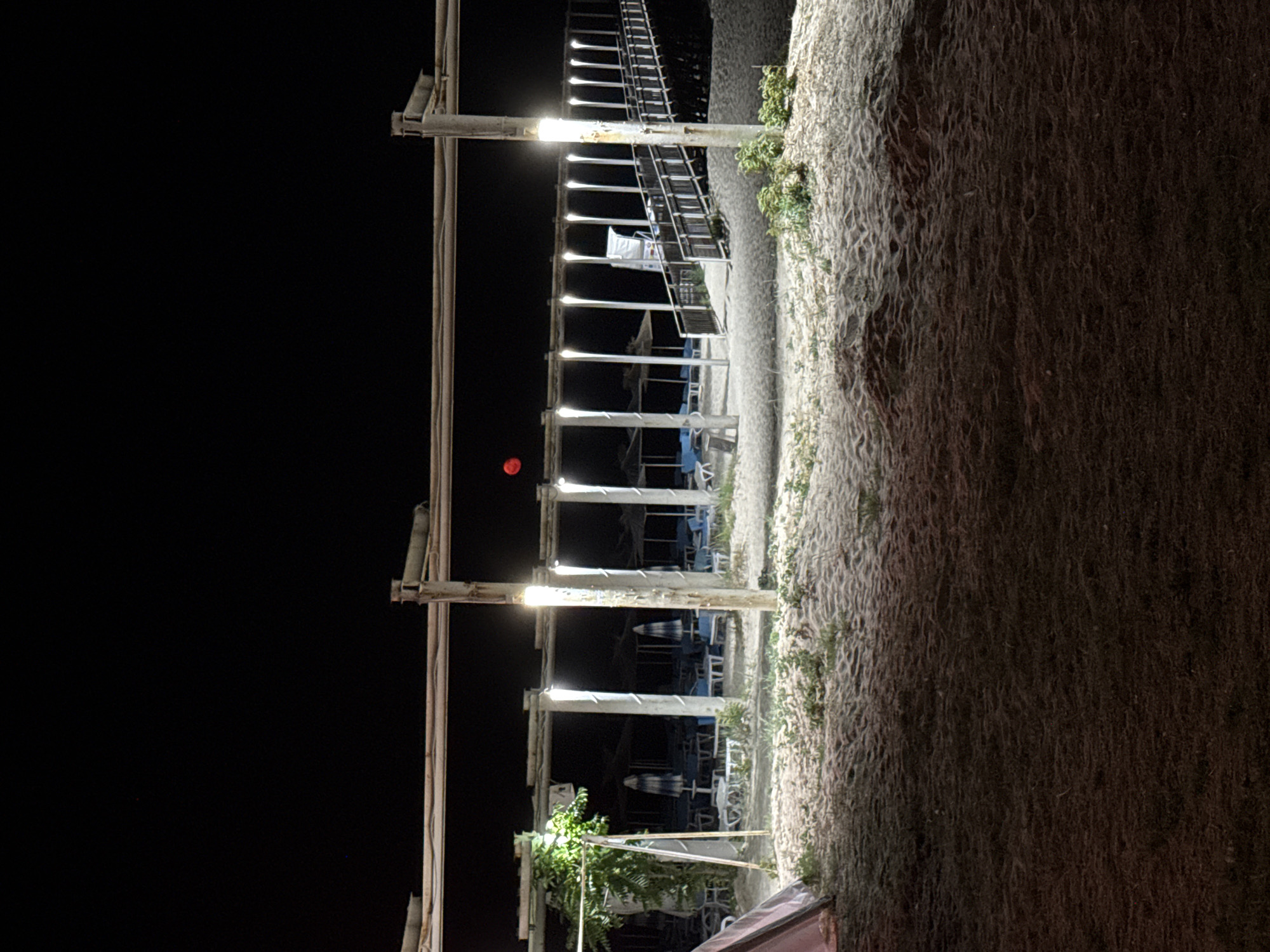 Full moon night at the beach, pier, and shoreline