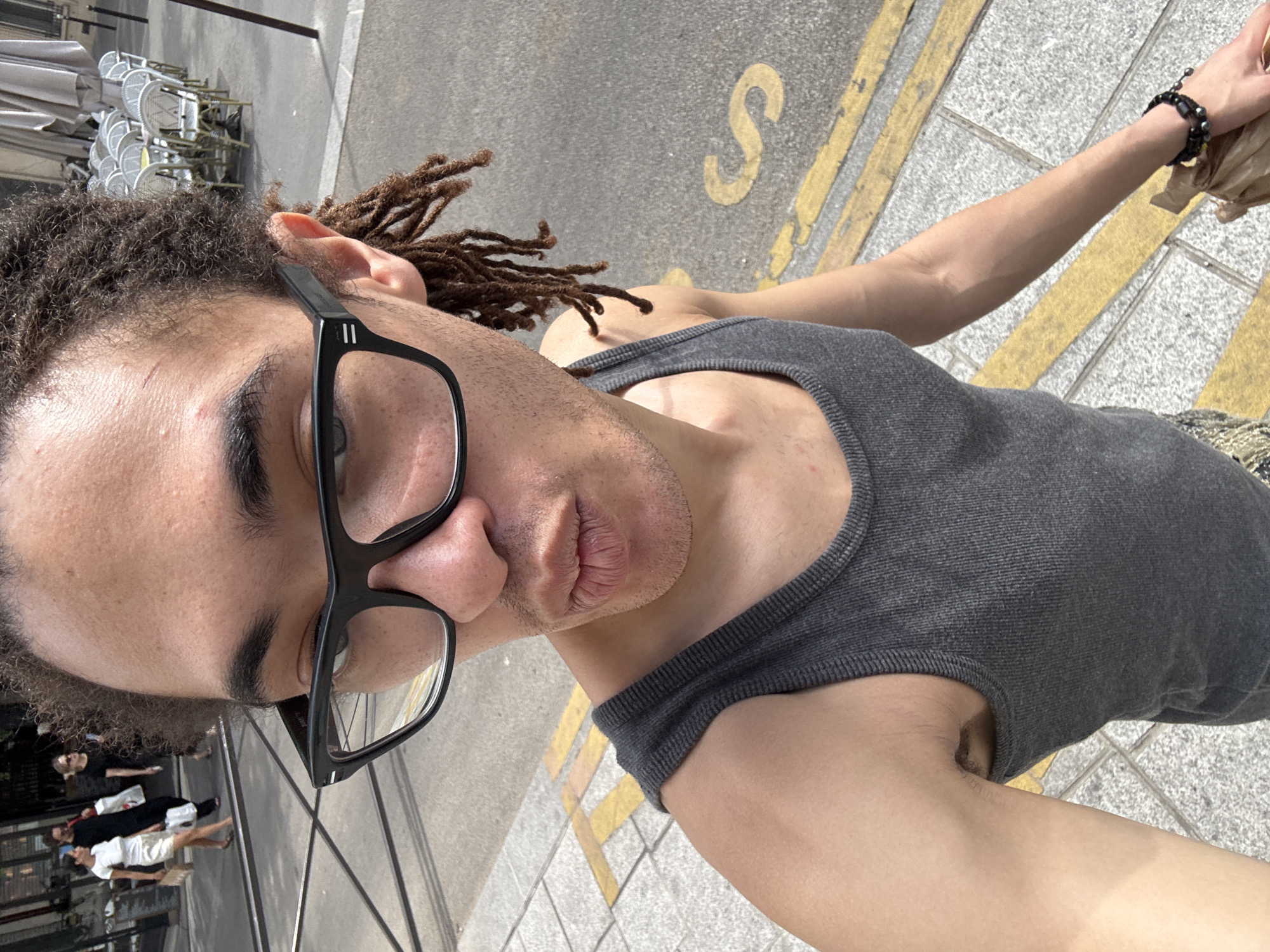 Selfie moment on a Paris sidewalk near a café