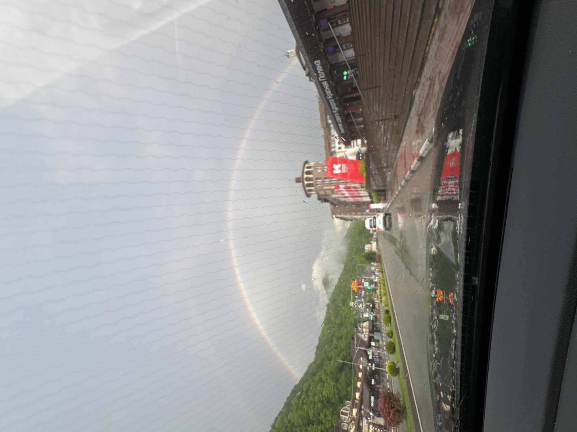Rainbow appears over Russian mountain resort during afternoon rain