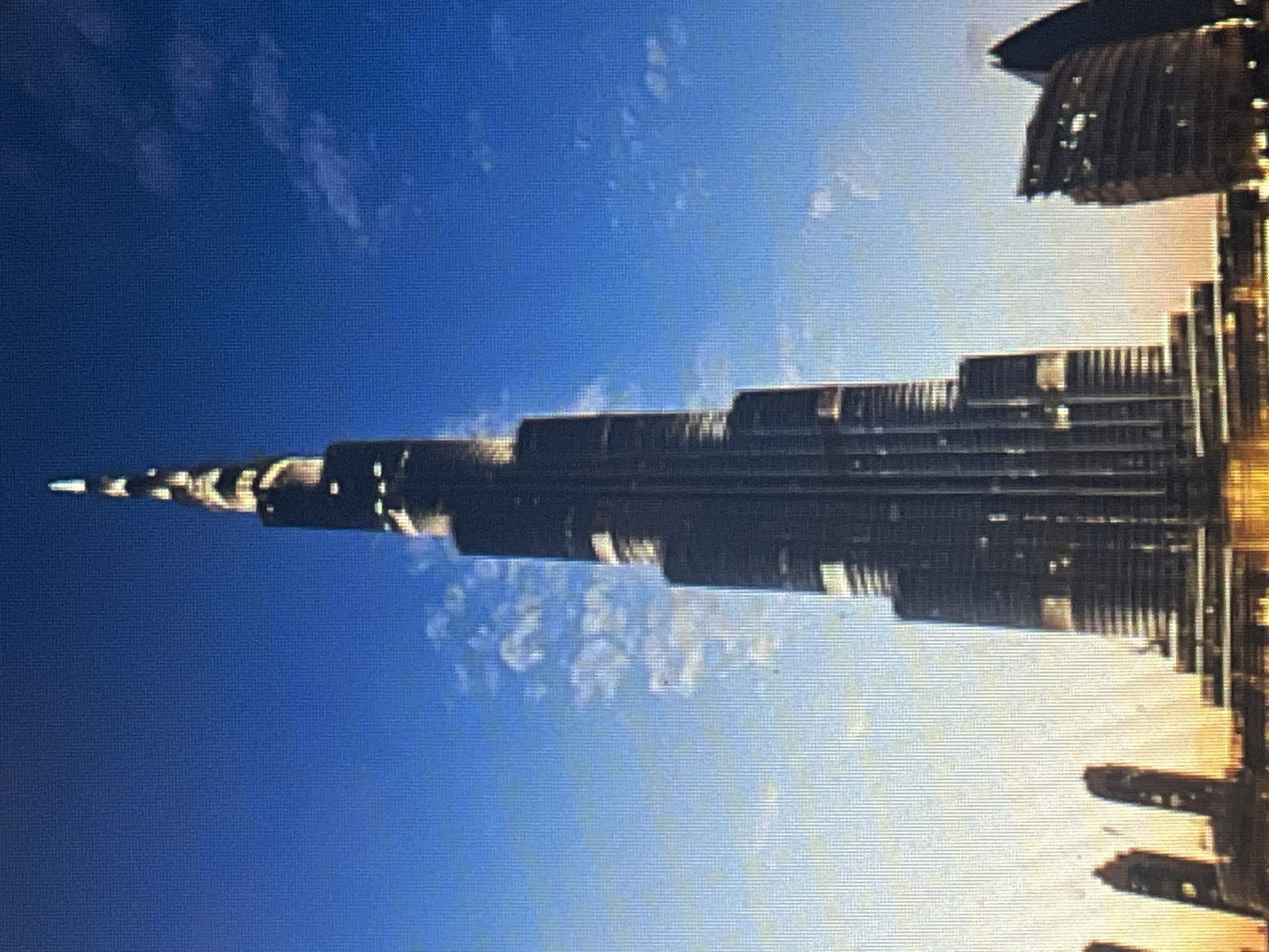 Burj Khalifa at dusk alongside a playful raccoon illustration