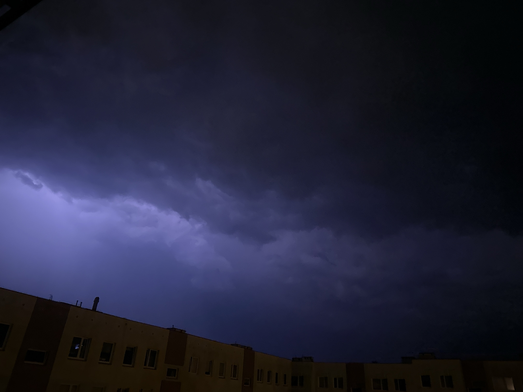 Lightning storm rolls over Świdnica apartment buildings at night