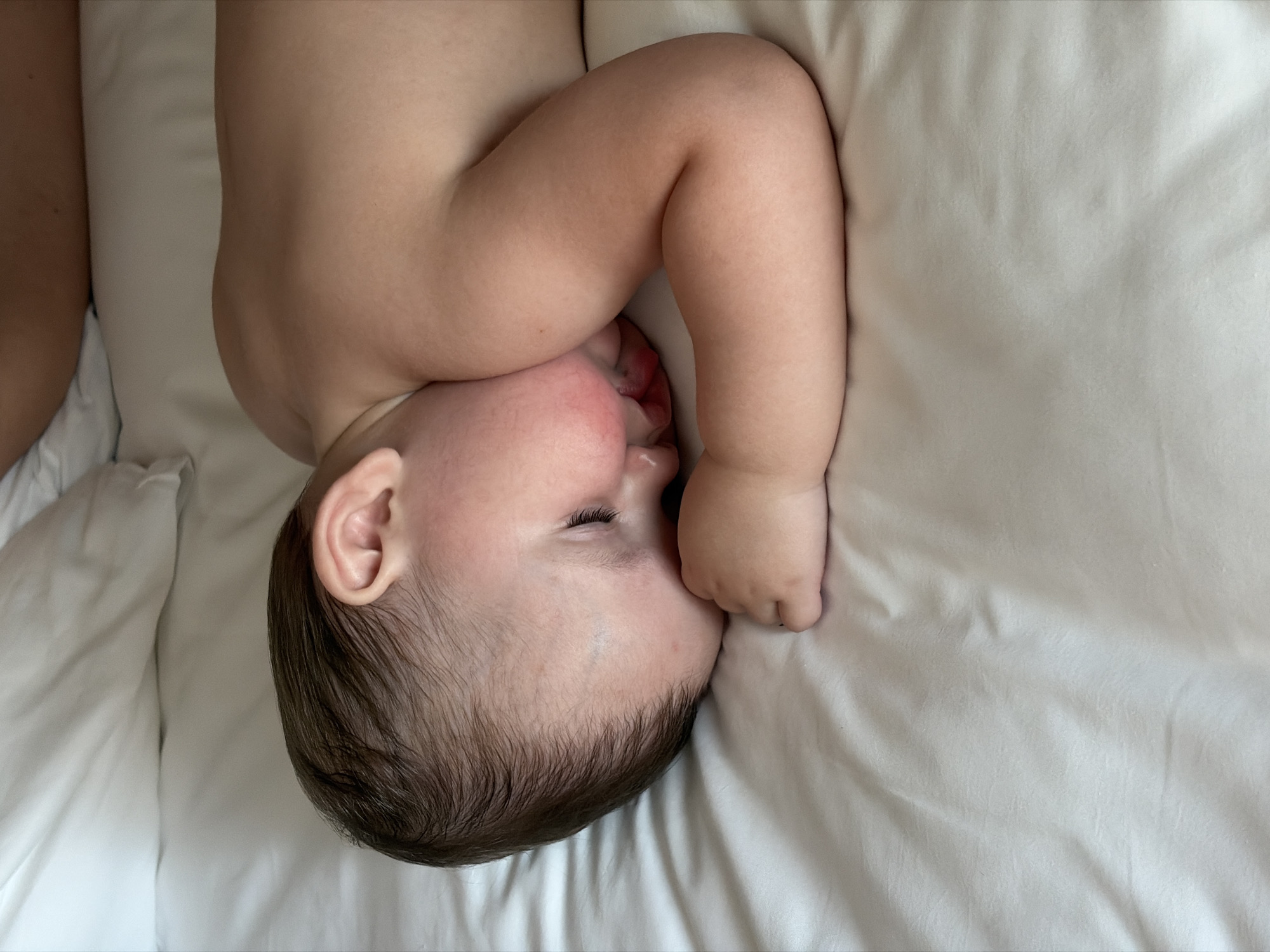 Baby observed resting on white sheet in Đà Nẵng
