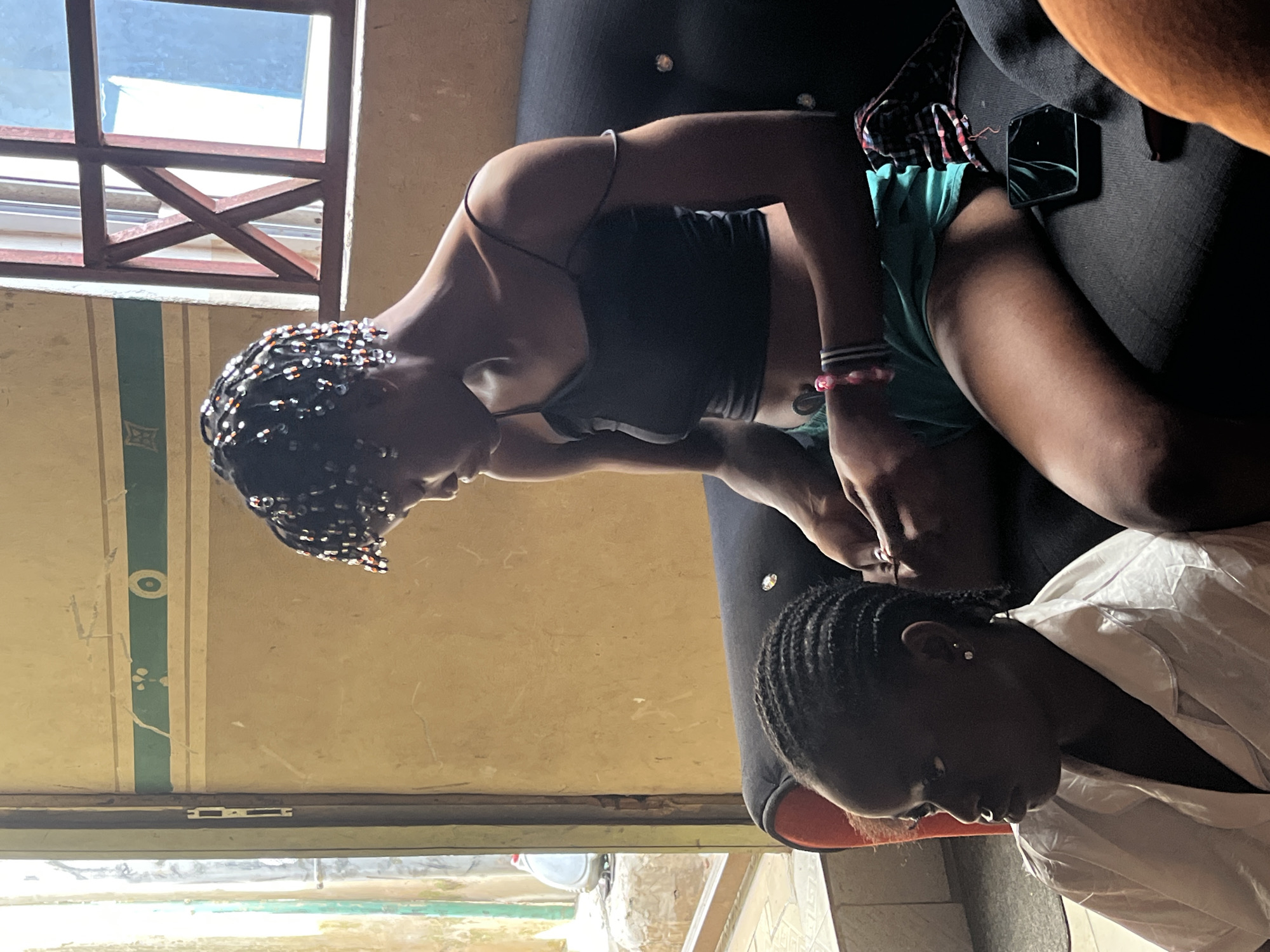 Hair braiding session documented in Badagry residential setting