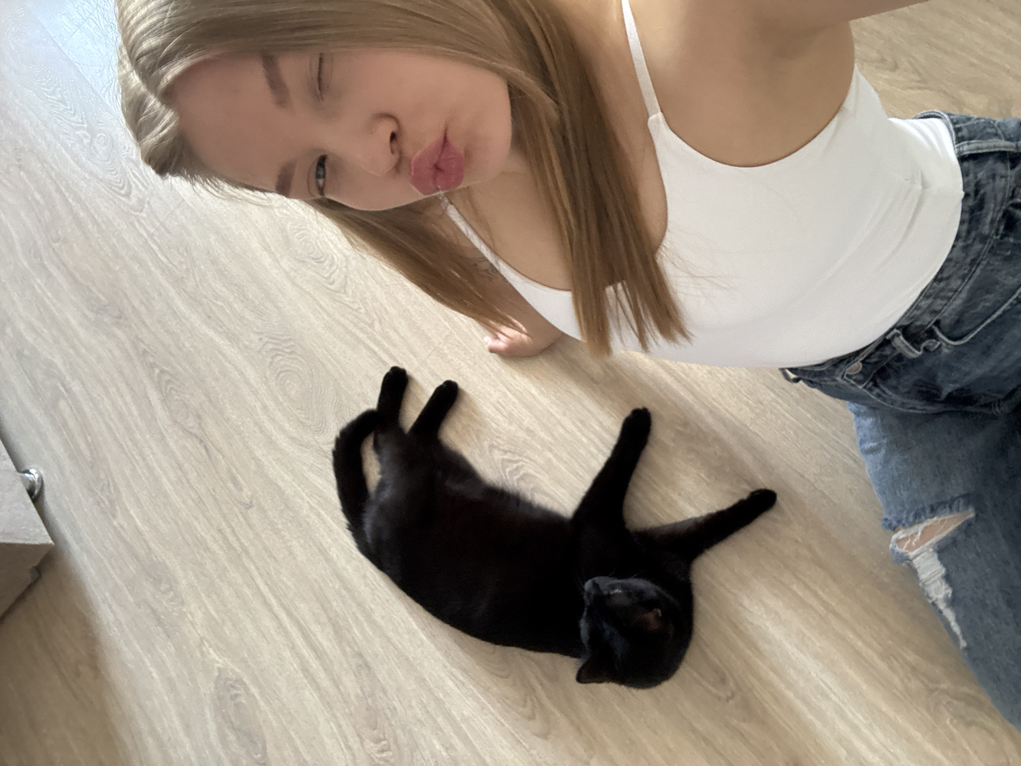 Woman takes playful selfie with cat in Chaikovsky home