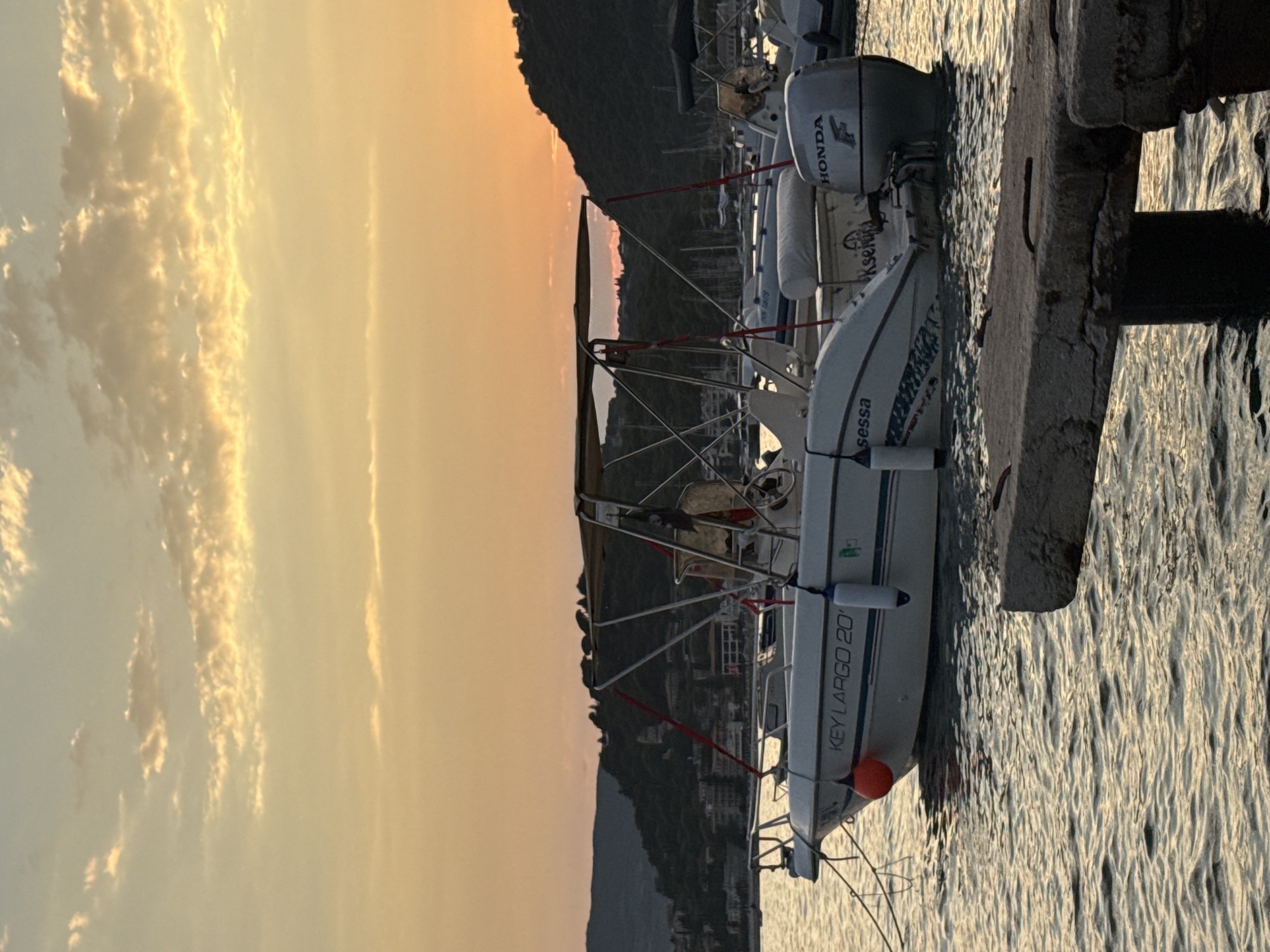 Sunset boats and shoreline crabs along the Sasovići waterfront
