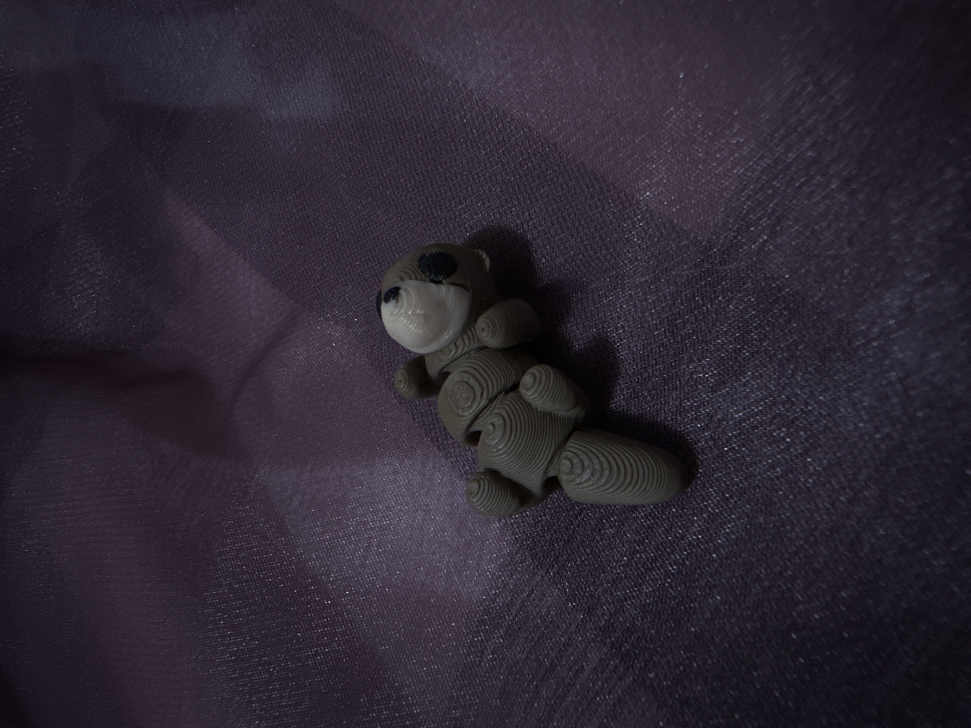 3D-printed toy bear photographed on fabric in Puebla