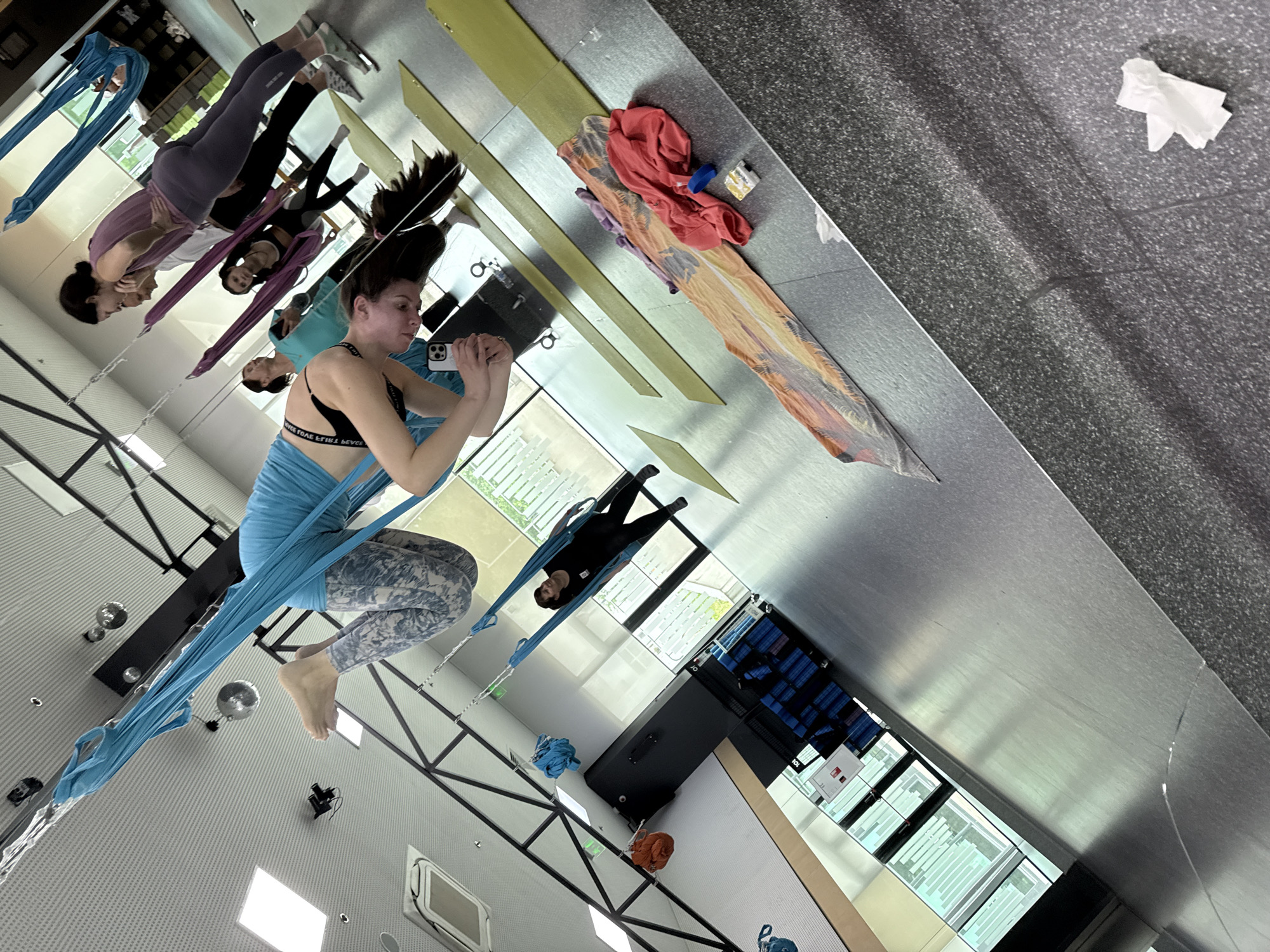 Woman Takes Selfie While Suspended in Aerial Yoga Hammock
