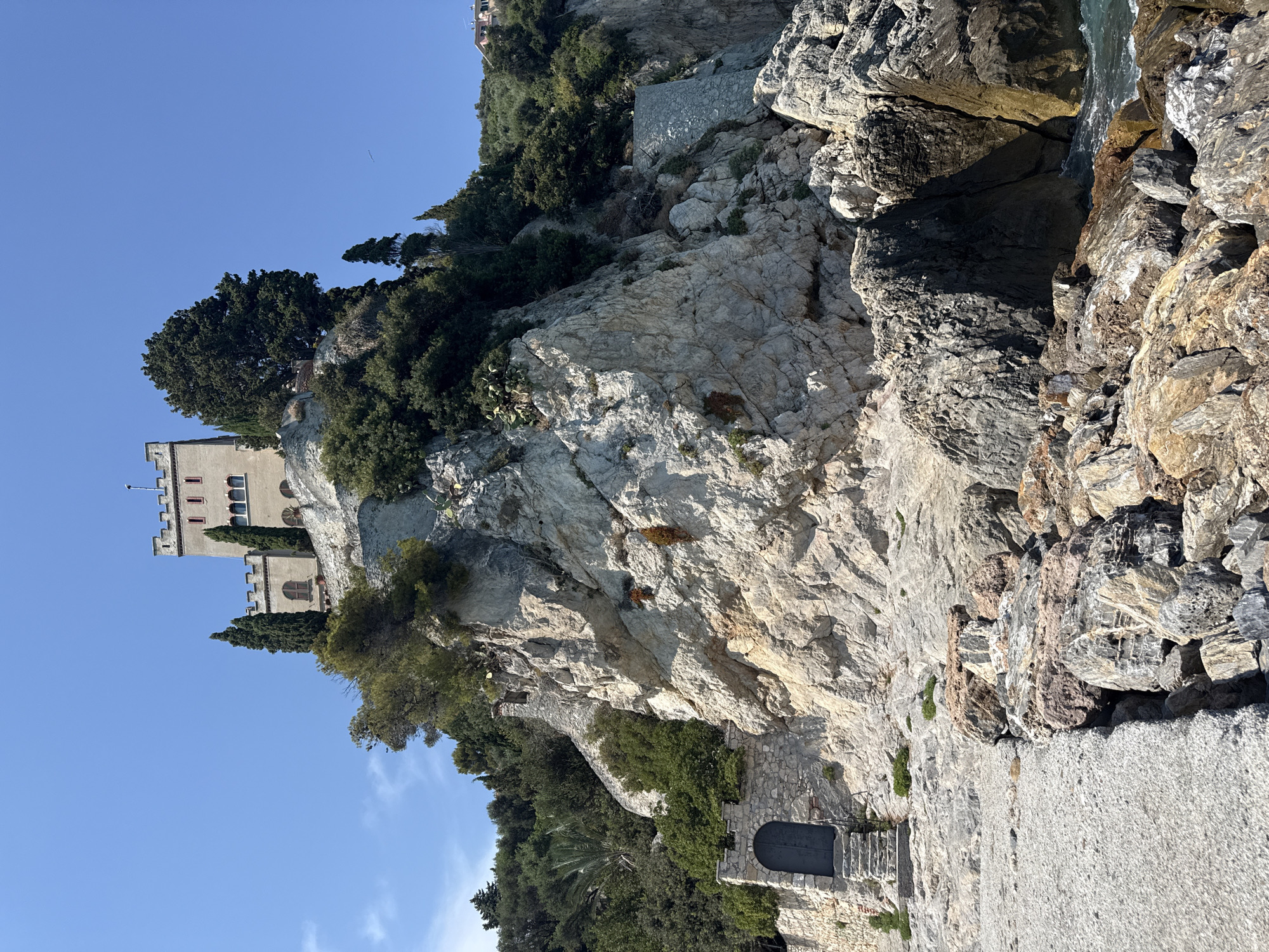 Sun, pebbles, and a clifftop castle on the Ligurian coast