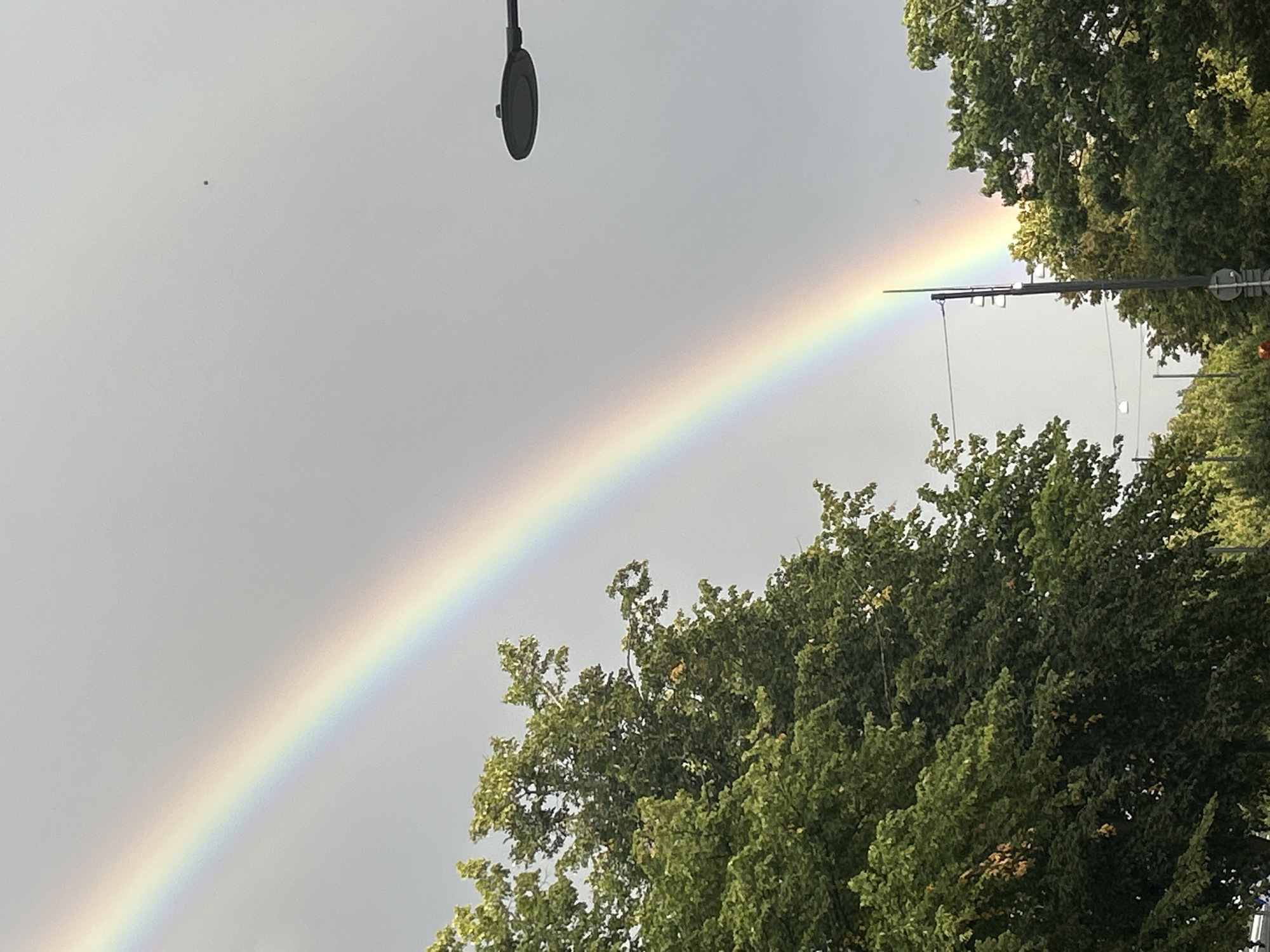 Faint rainbow over Helsingborg streets on a grey afternoon