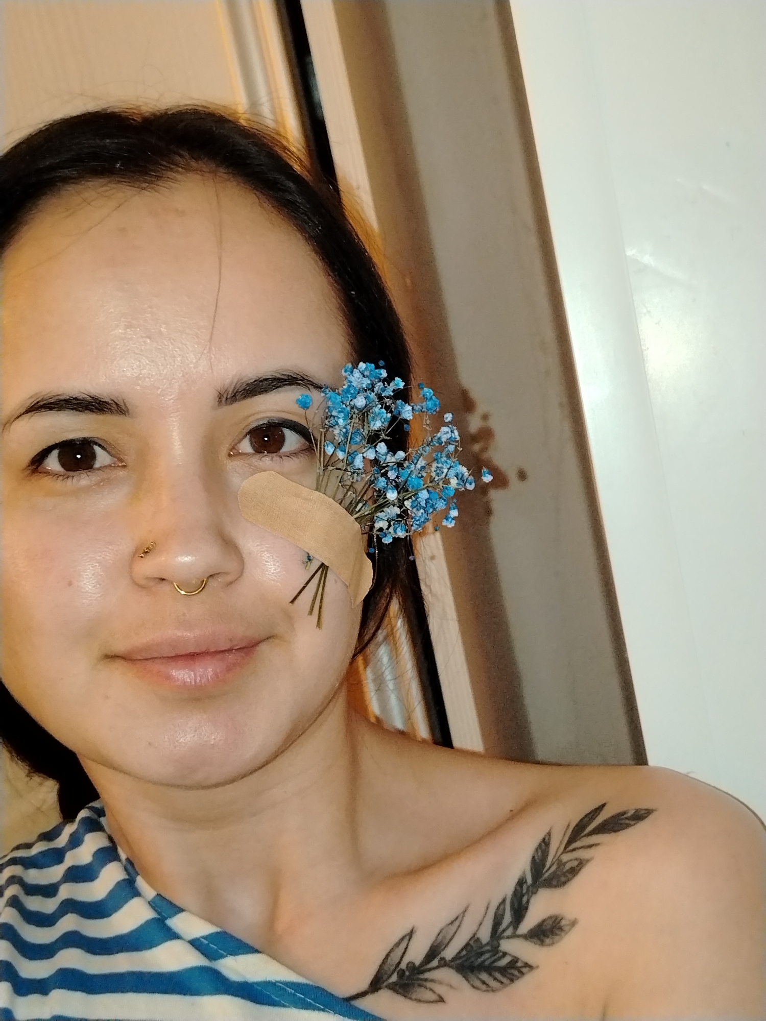 Woman applies makeup with bandaged cheek in Noviy, Russia