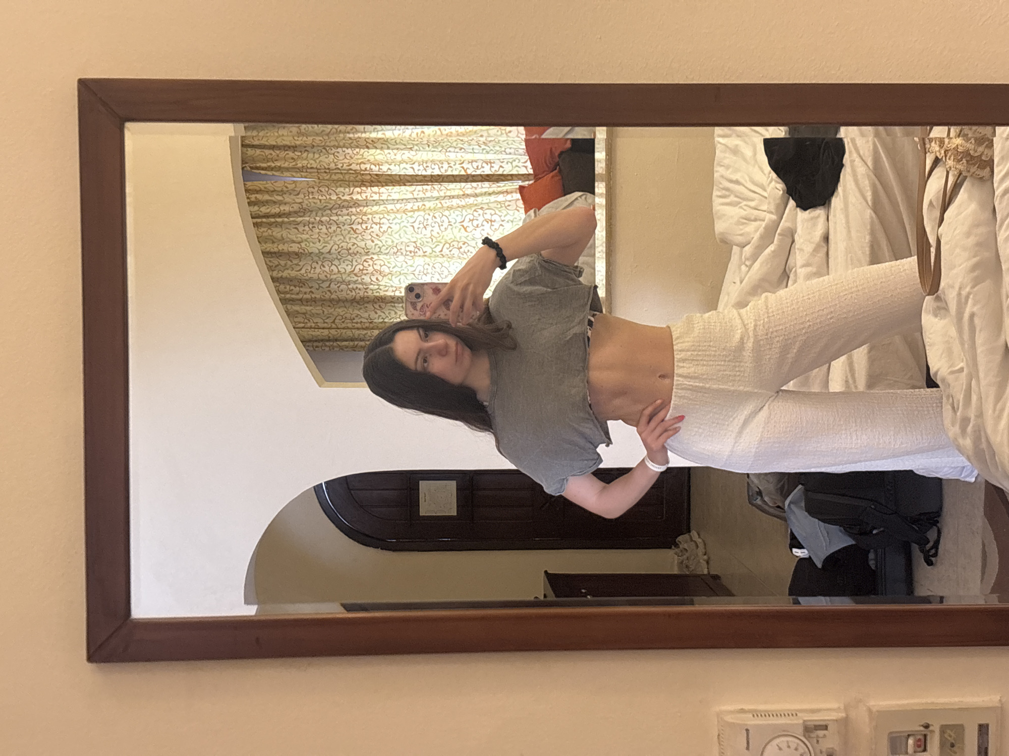 Woman takes mirror selfie in Sharm El Sheikh hotel room