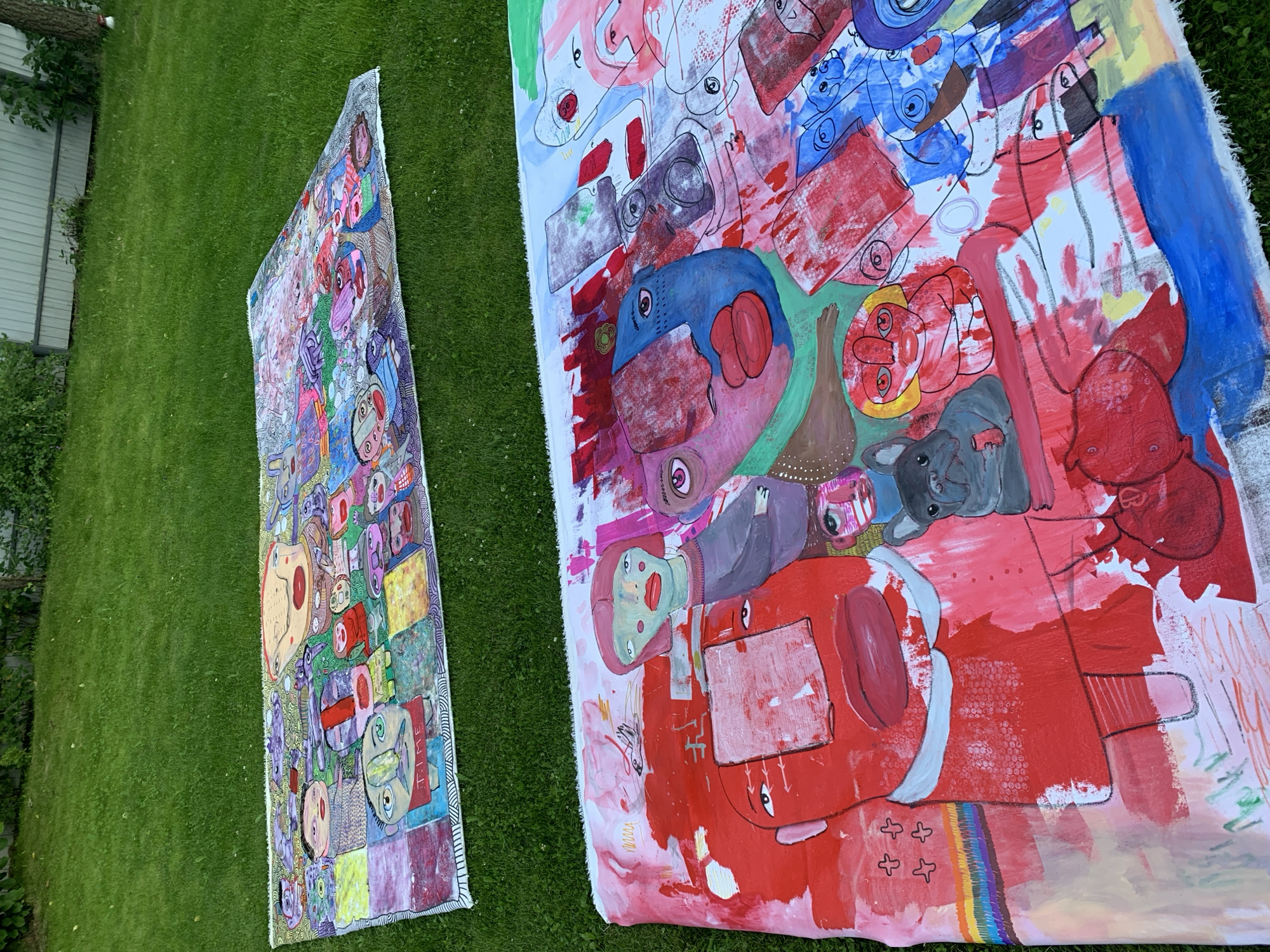 Folk art face sculptures displayed on a lawn in Sergeevo