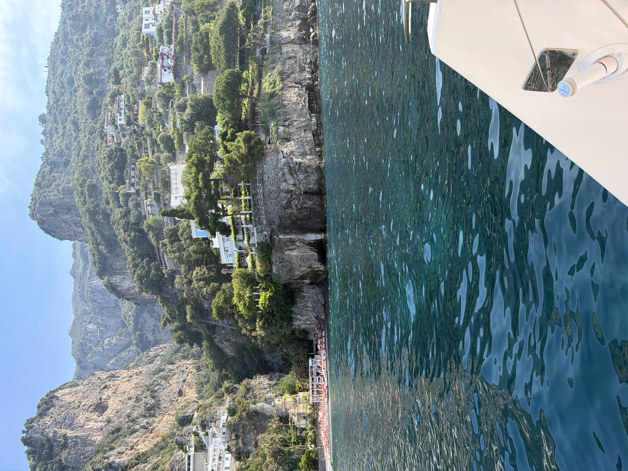 Boat passengers capture scenic Italian coastline views near Positano