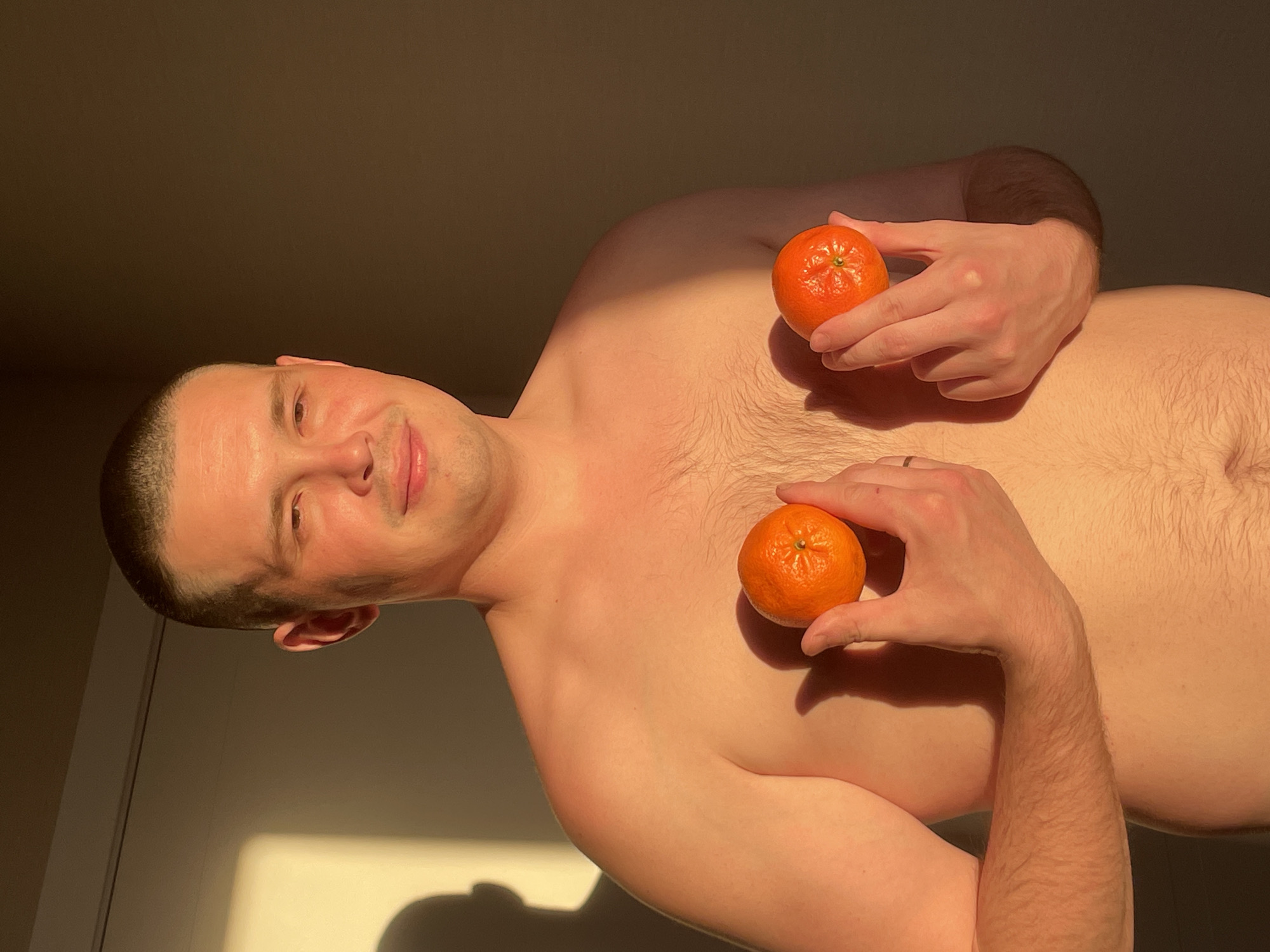 Man holds tangerines in Russian village, tagged #Fruit