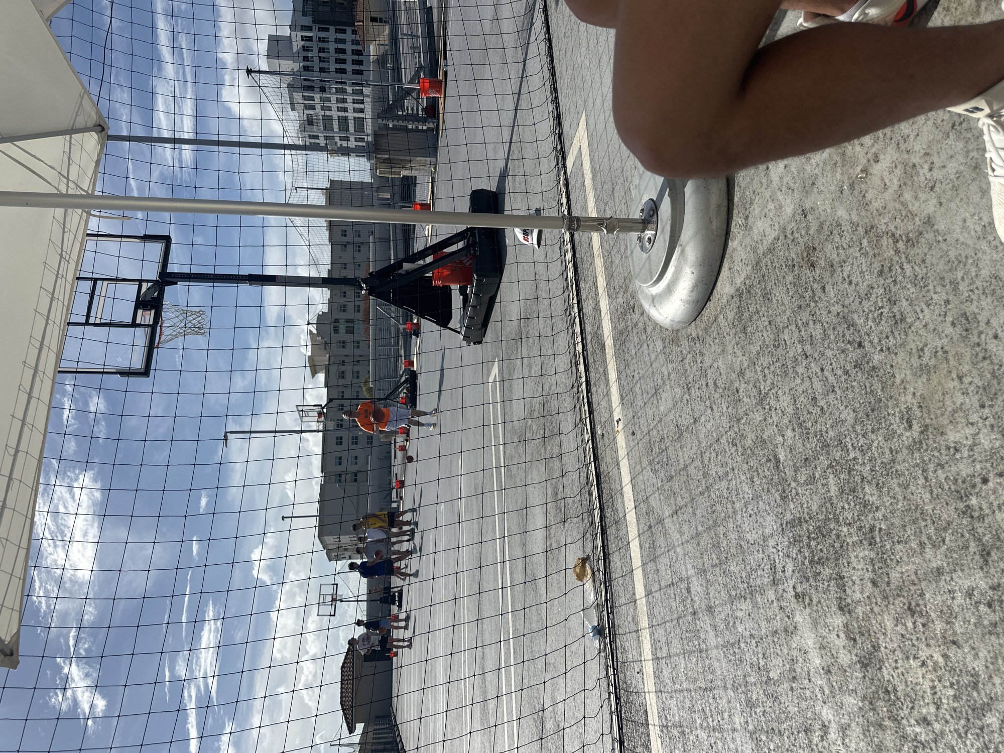 Evening basketball game observed on outdoor court in Aventura