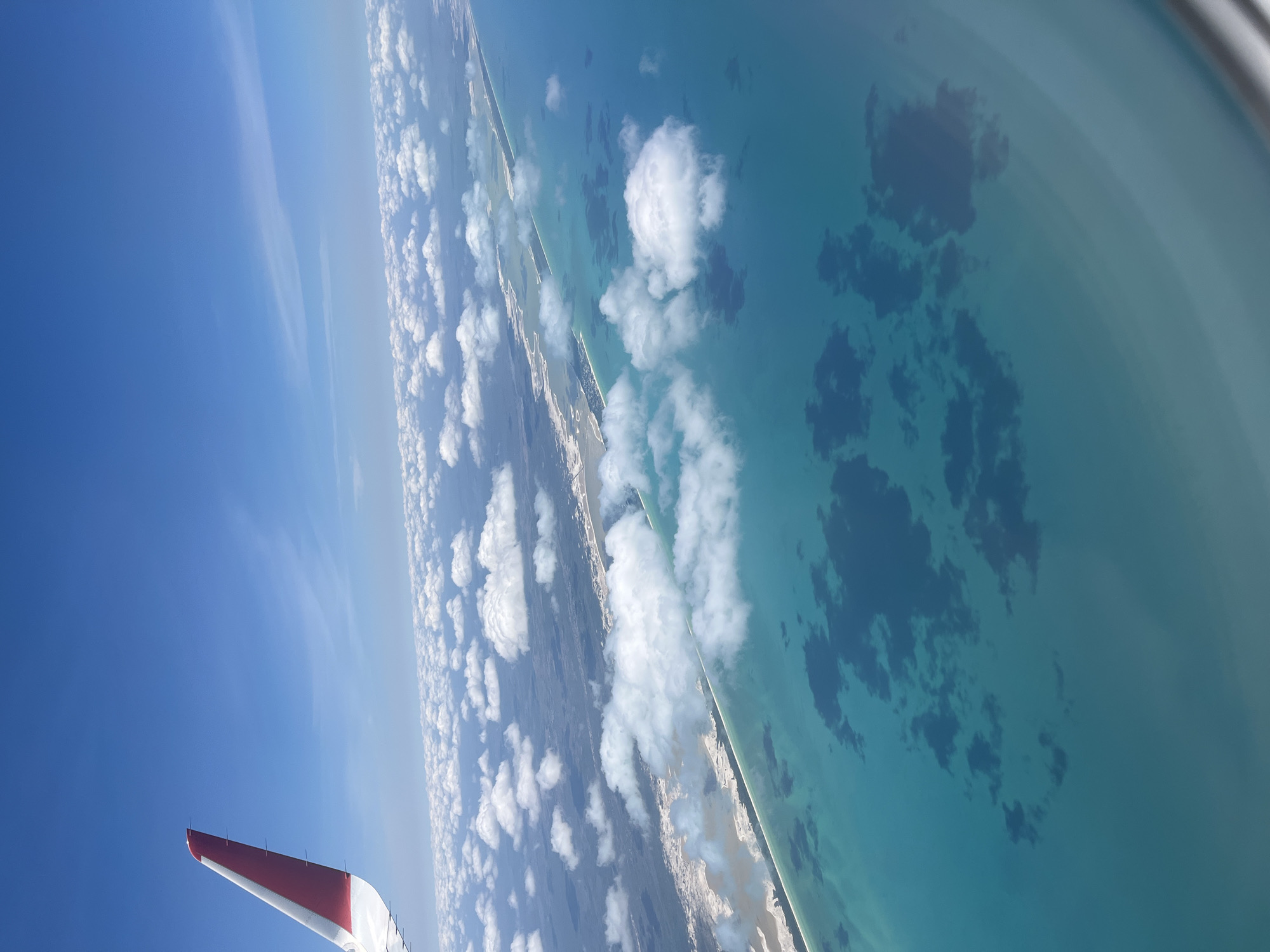 Aerial view captures tropical Mexican coastline from airplane window