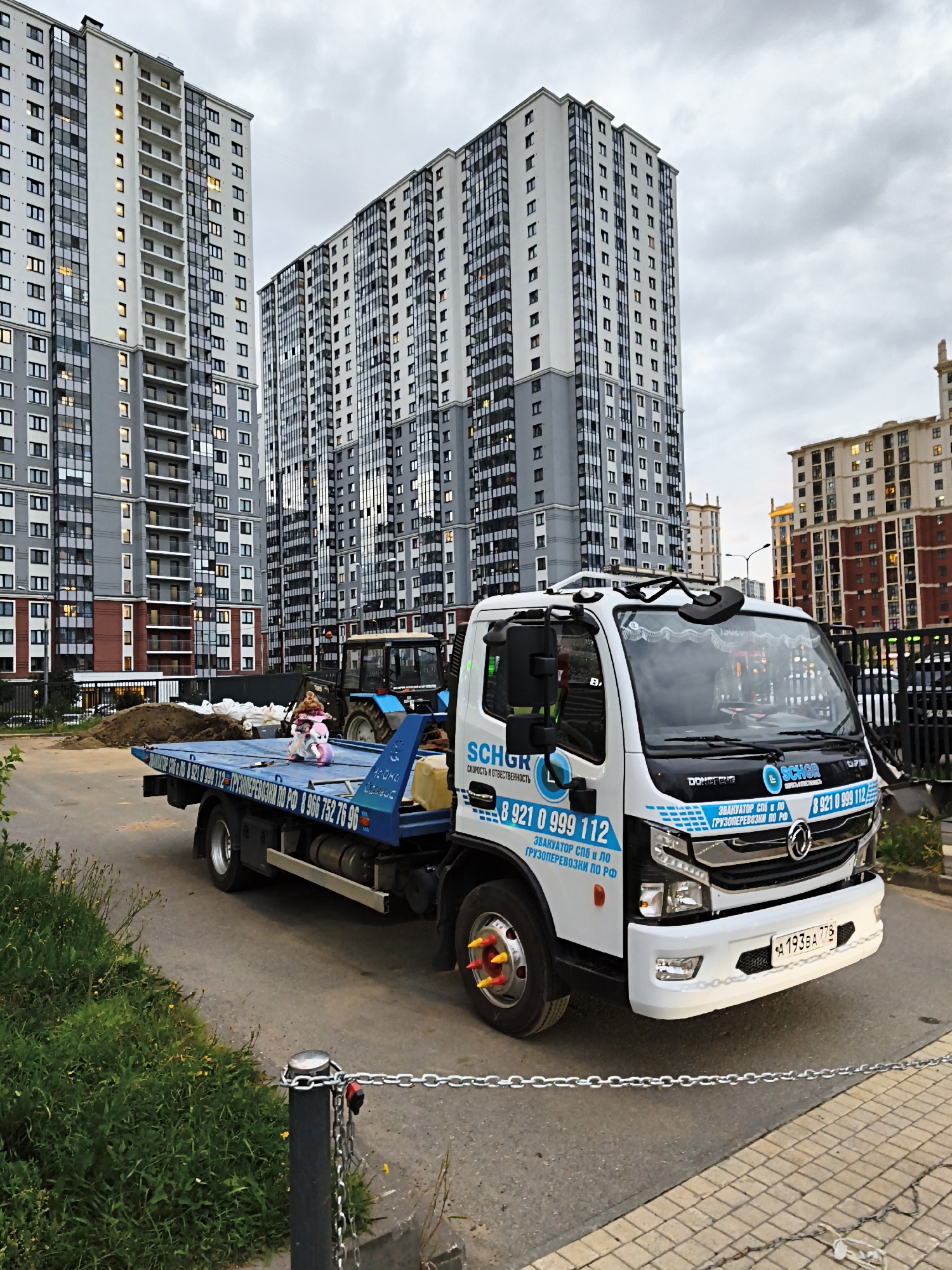 St. Petersburg tow truck parked with a doll strapped to its flatbed