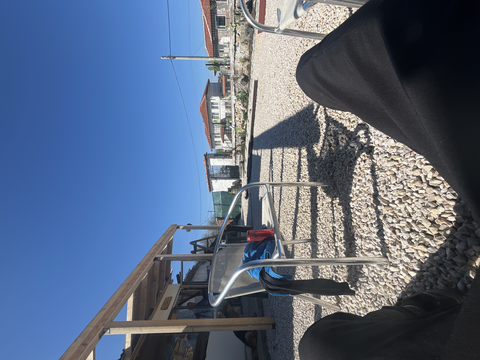 Person sits with belongings amid construction in Bulgarian village