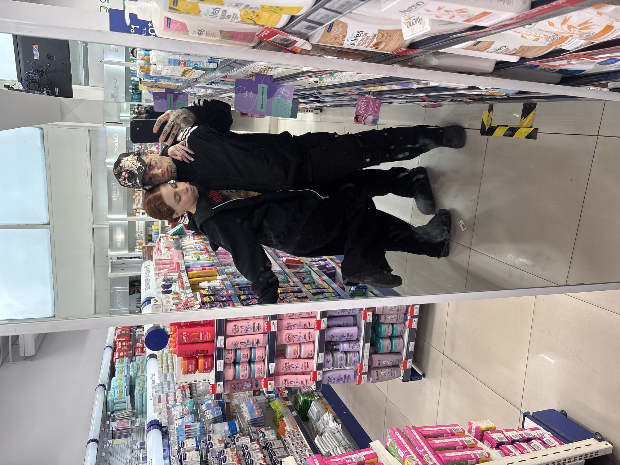 Two people take selfie in Buenos Aires store aisle