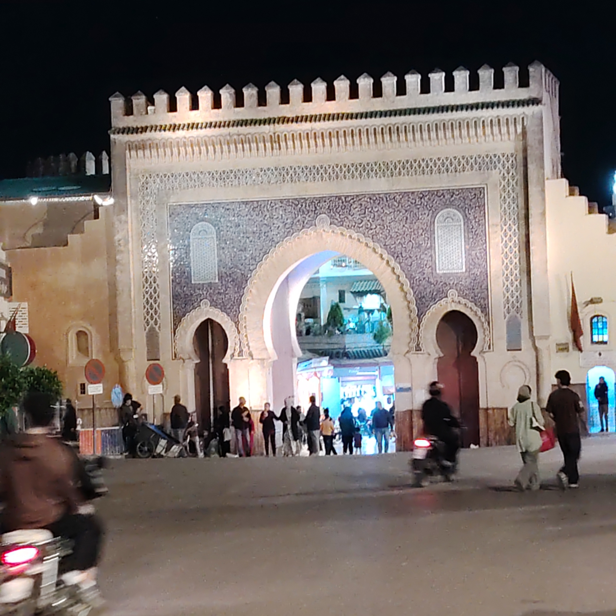Historic Bab Bou Jeloud gate illuminated at night in Fez