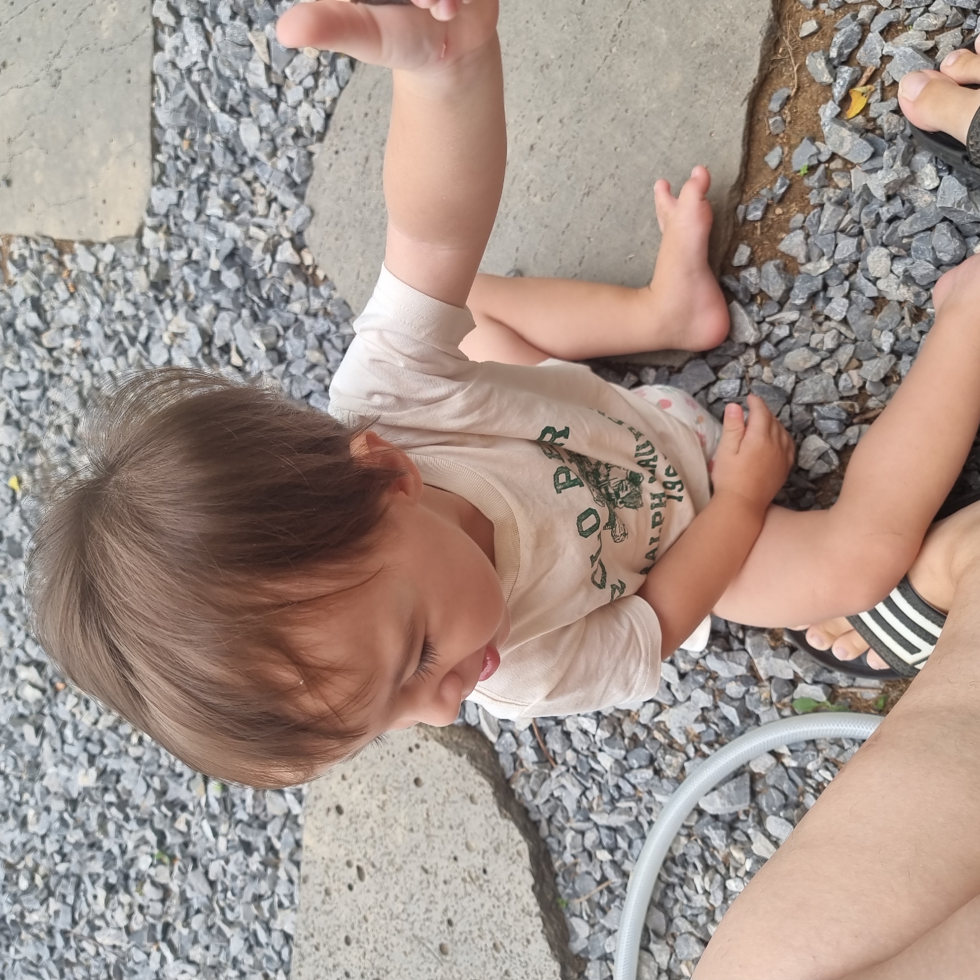 Toddler and farm equipment share a rural South Korean homestead