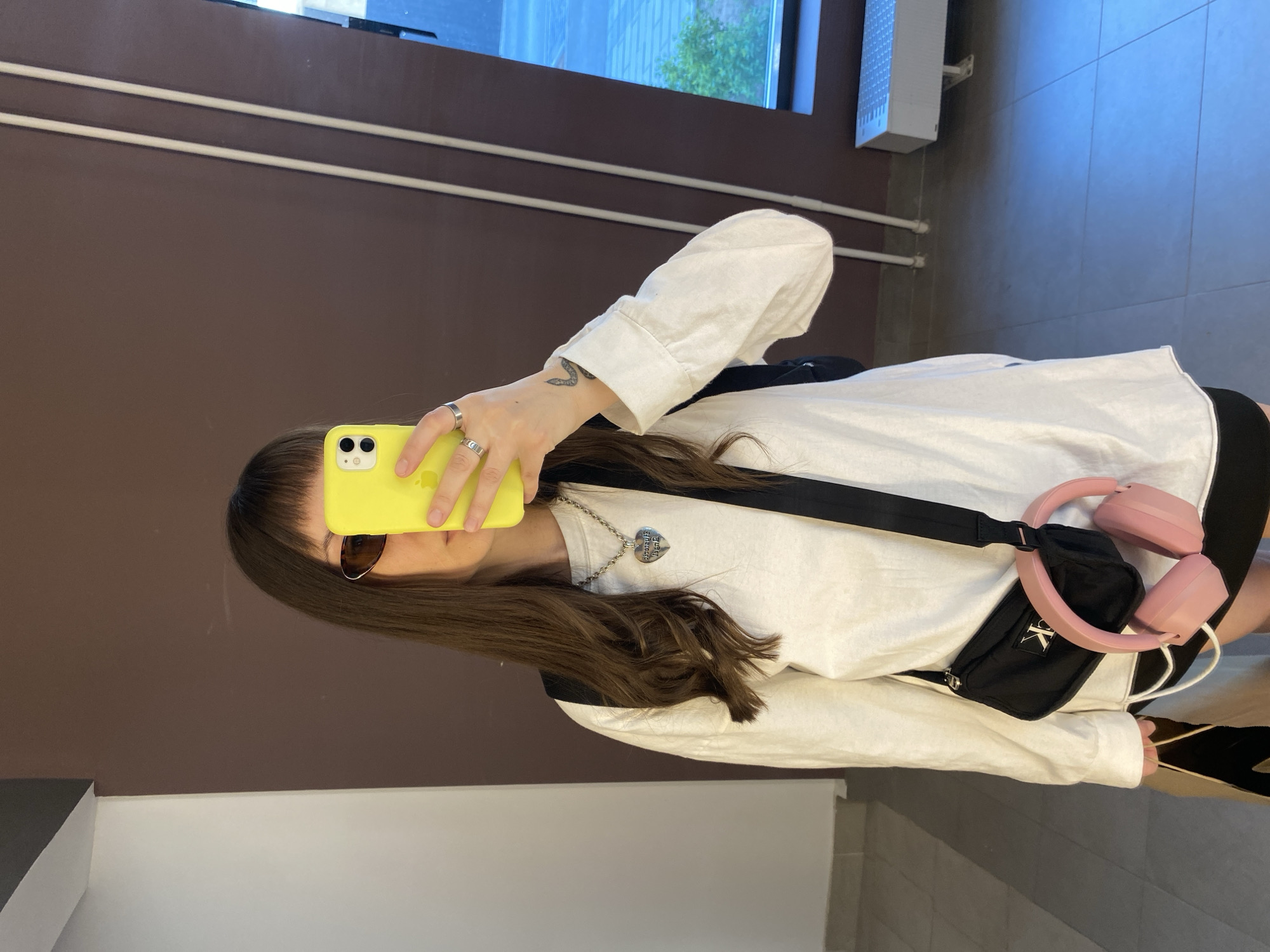 Person takes mirror selfies in Izhevsk apartment building corridor