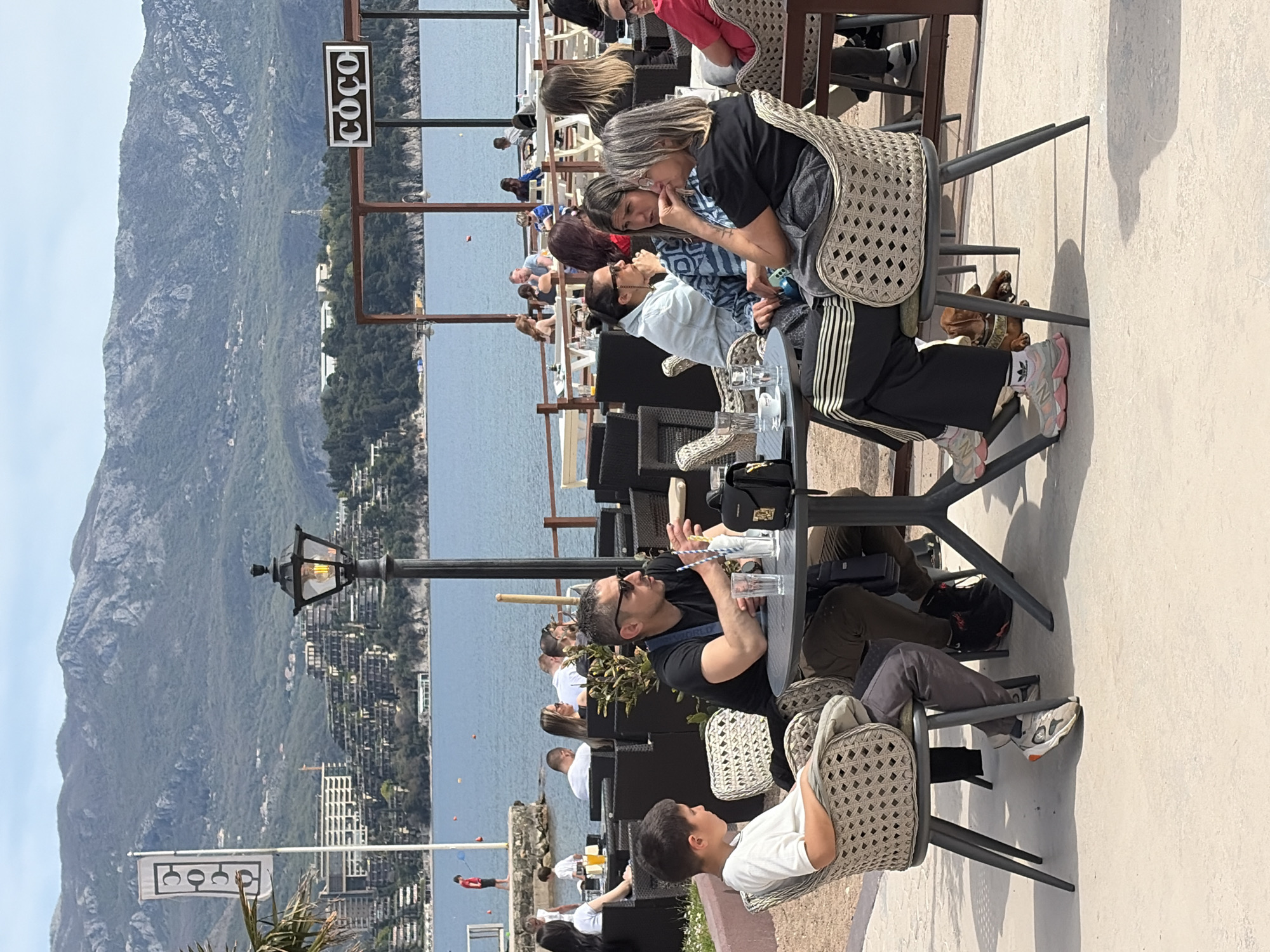 Tourist poses for photos at Budva waterfront Montenegro