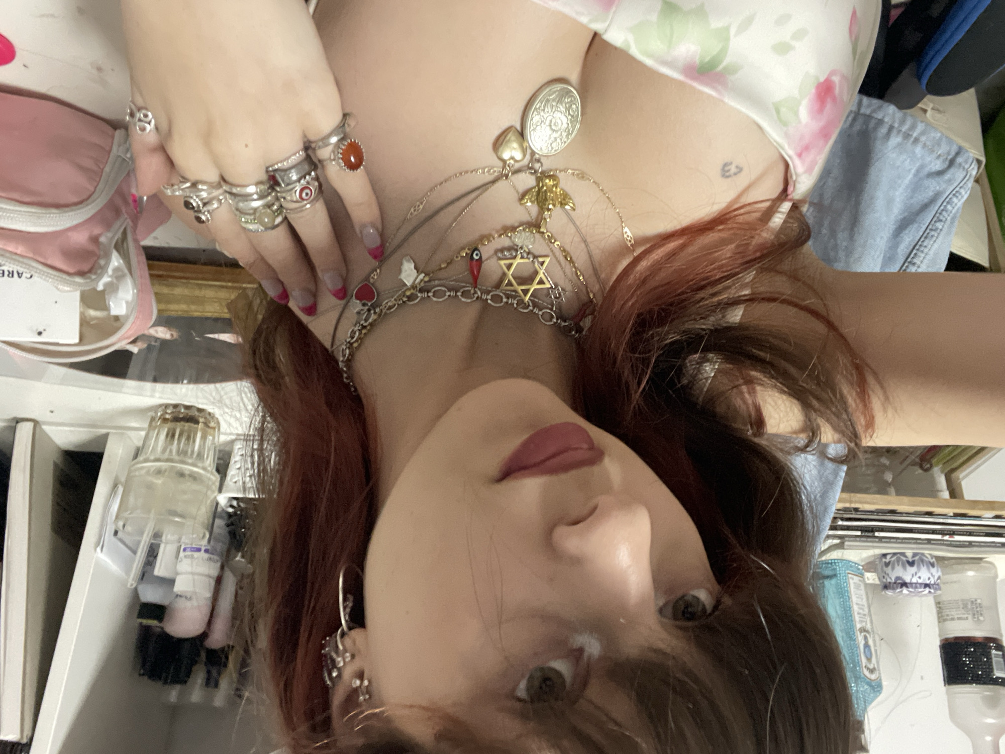 Woman takes multiple mirror selfies in decorated bedroom Ra'anana