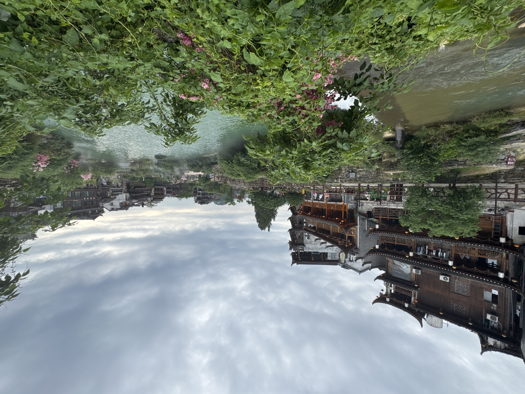 Morning mist rises over Furong Ancient Town river