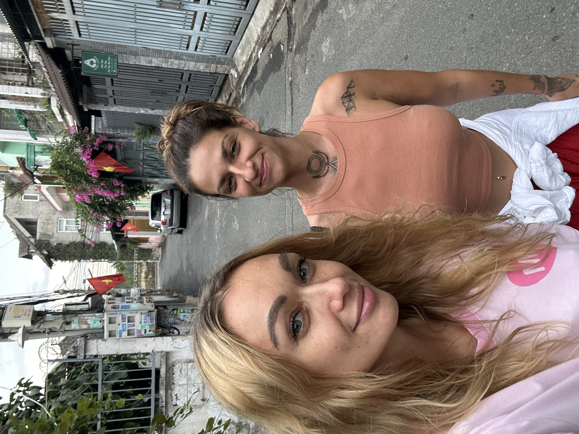 Two women take selfie on street in Vietnam