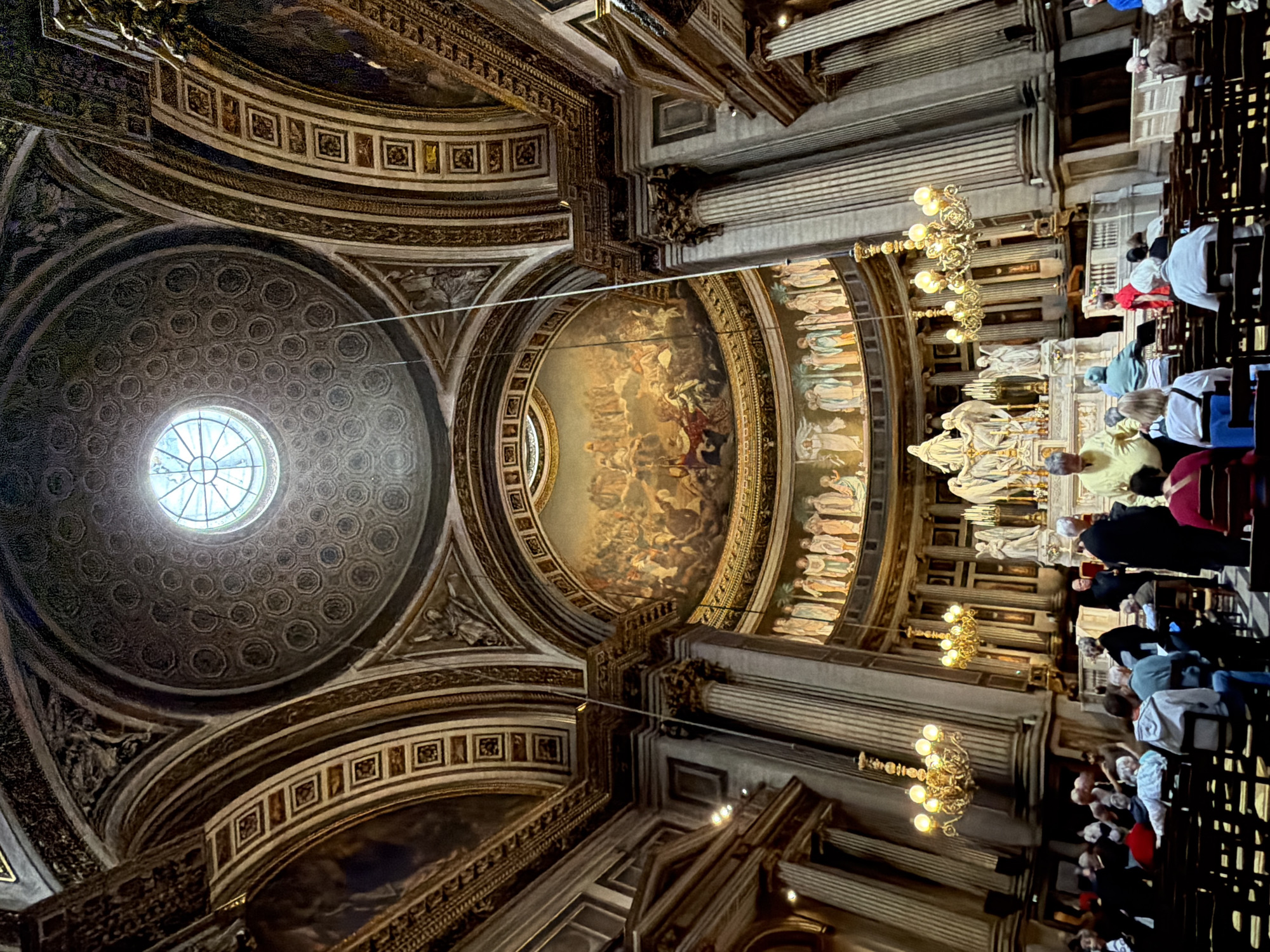 Visitor documents ornate interior of Madeleine Church in Paris