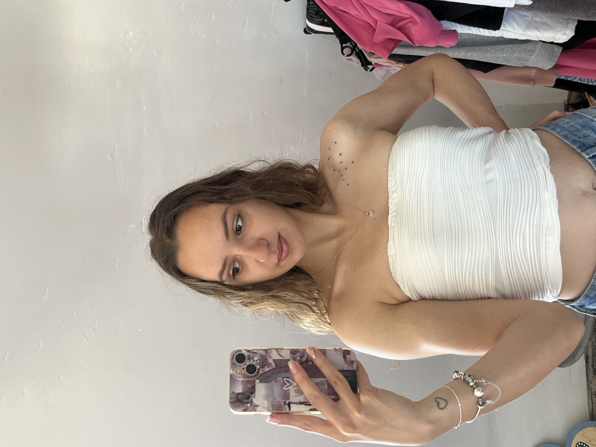 Woman takes multiple selfies indoors in Saarbrücken