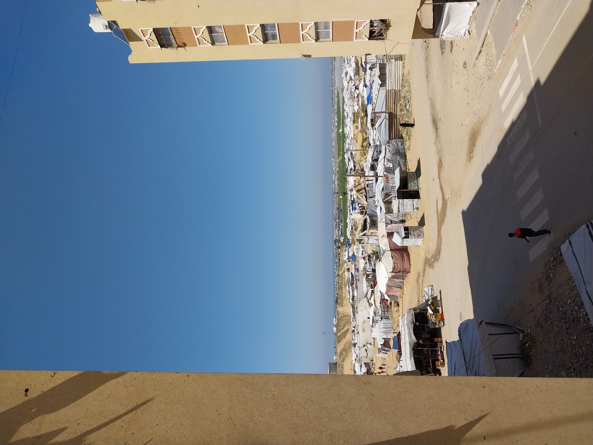 Aerial views capture refugee camp and damaged building