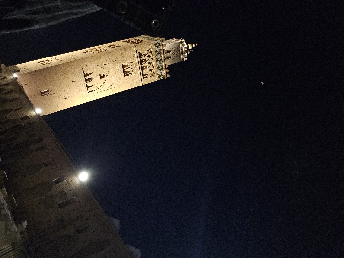 Tourist documents evening visit to illuminated Marrakesh minaret