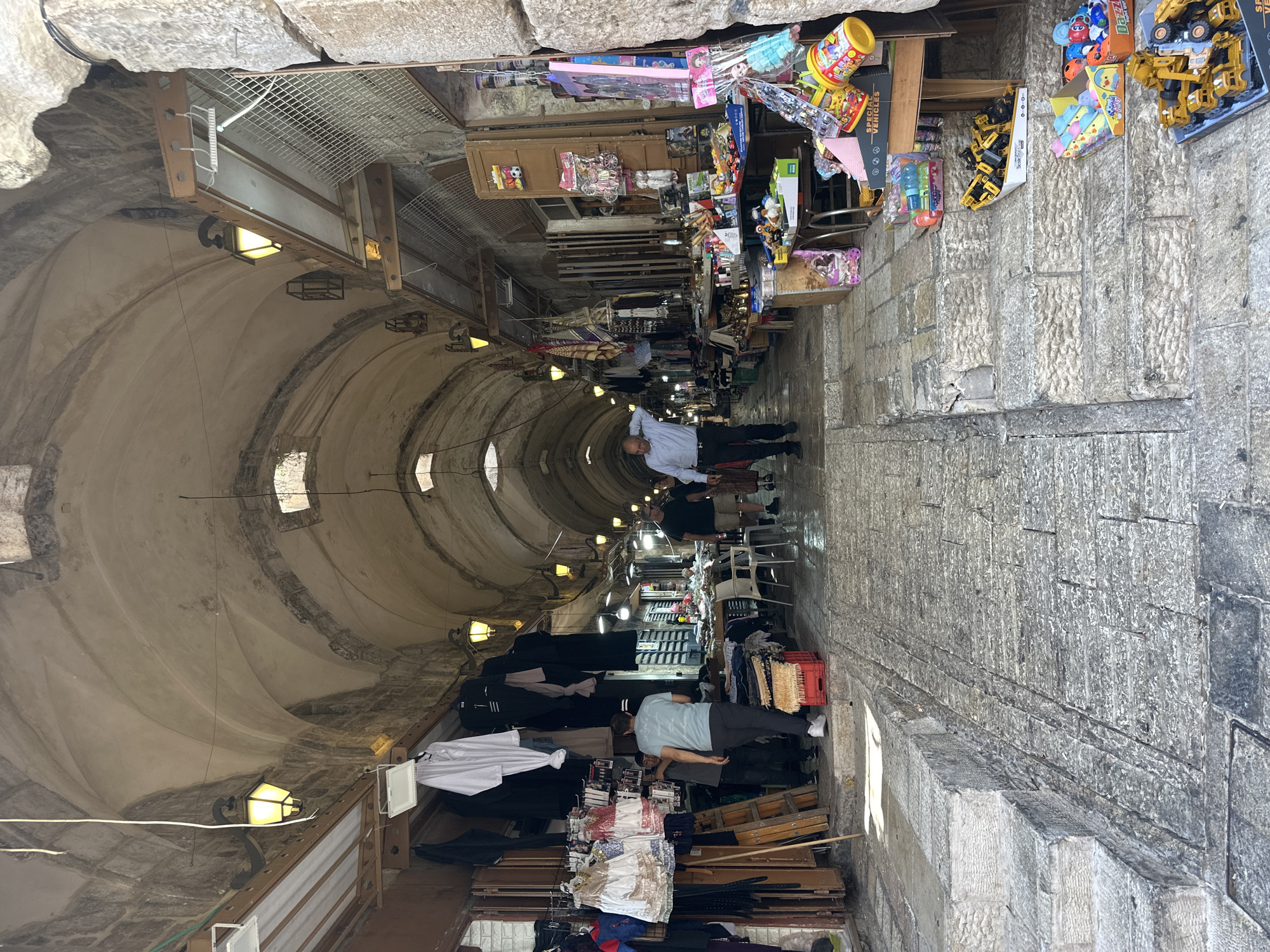 Tourist documents morning walk through Jerusalem Old City markets