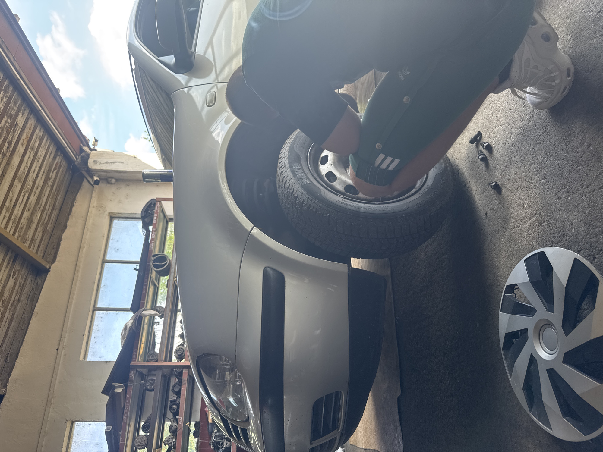Car maintenance underway at Yambol garage, wheel removed